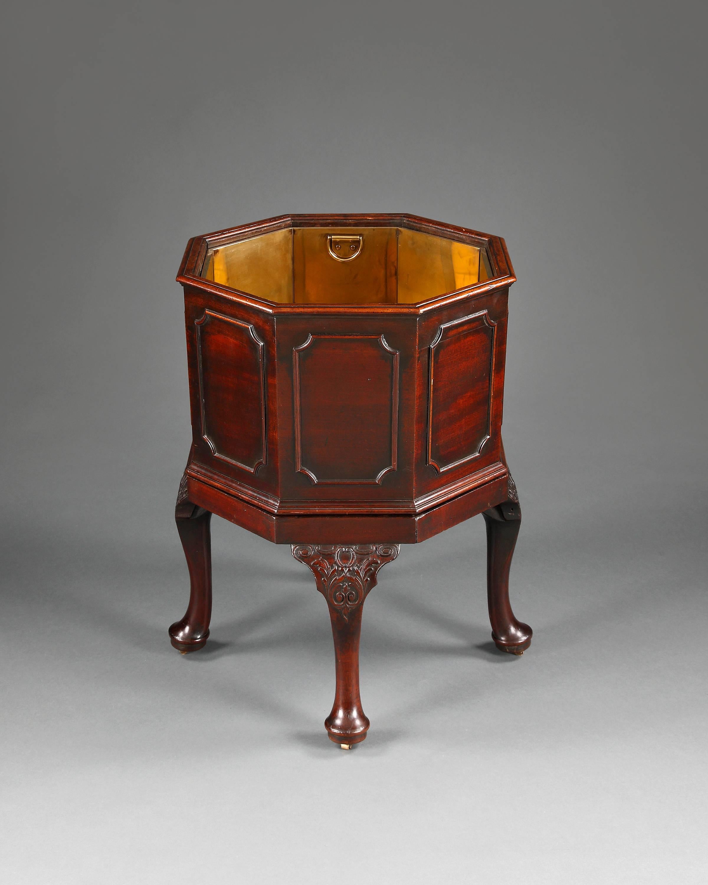 A fine example of Georgian cabinetmaking. The mahogany octagonal planter is in two parts. The upper section with a later brass liner and having rectangular shaped moulded panels with concave corners. This rests on the base of four cabriole legs each