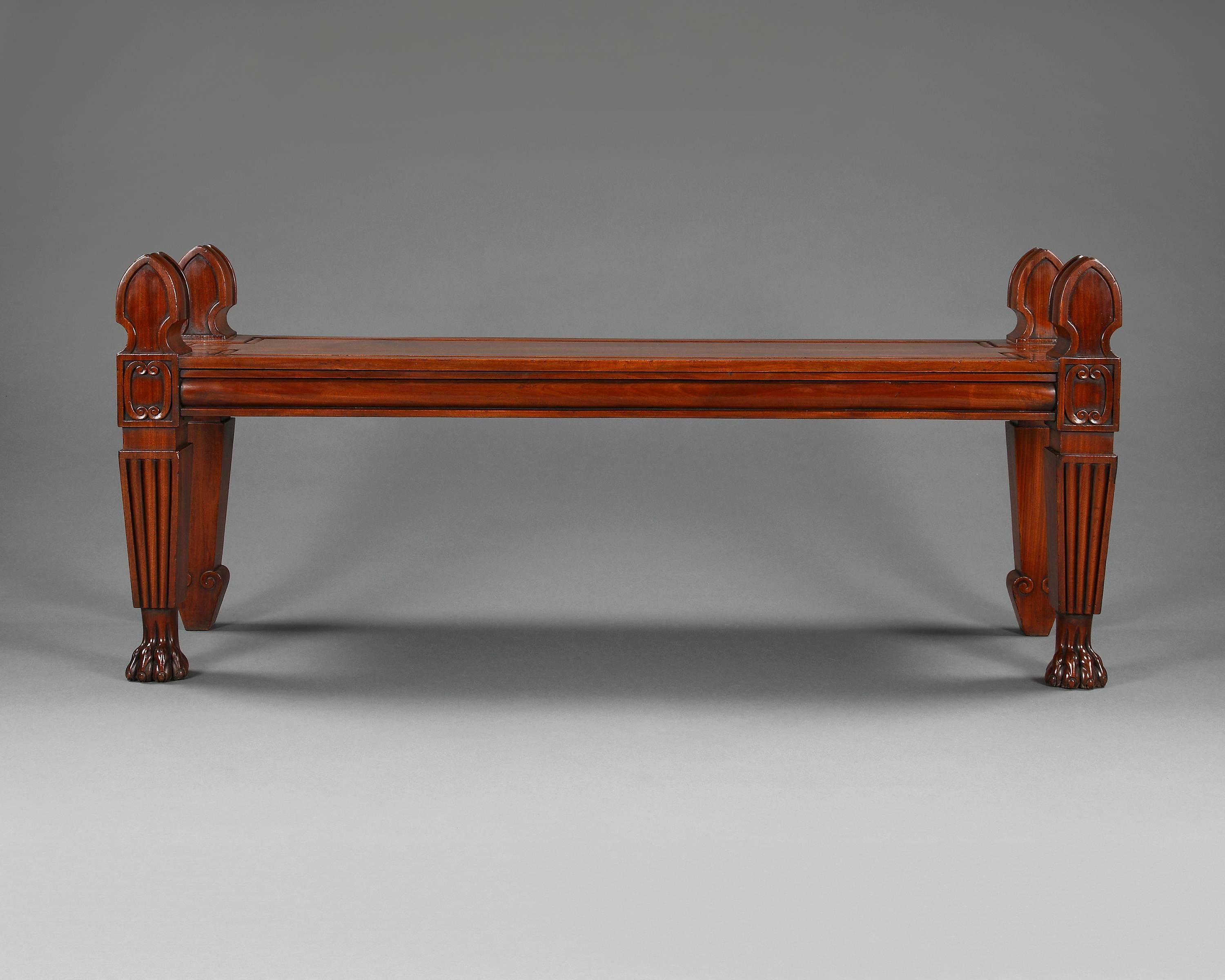 Very smart and stylish mahogany hall bench in the classical manner 'Roman', with a one piece panelled rectangular seat, square tapered legs, the front legs have a reeded section and raised on paw feet.