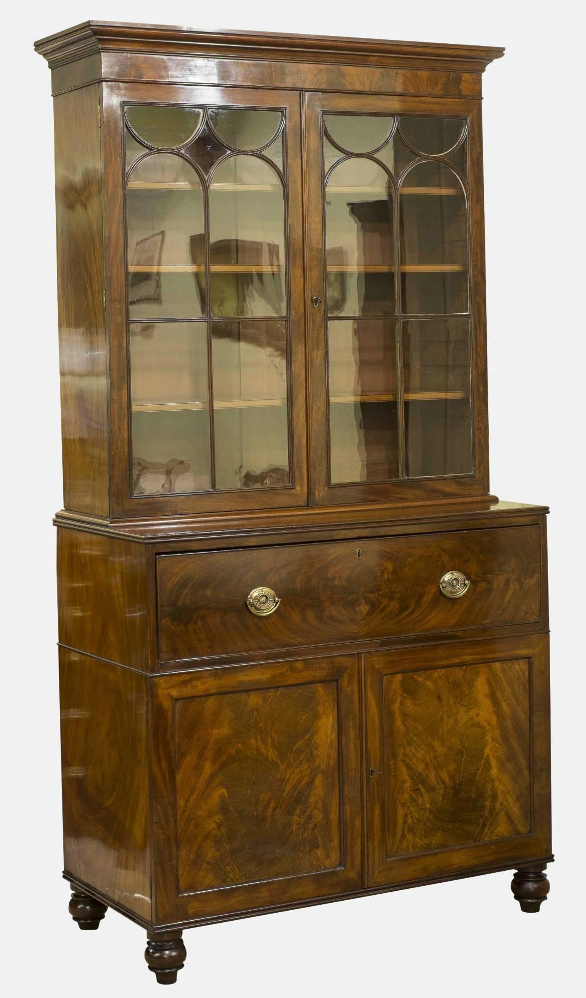 A very good William IV mahogany secretaire bookcase. The fall front enclosing an arrangement of drawers and pigeon holes, having an astragal glazed bookcase above circa 1830.