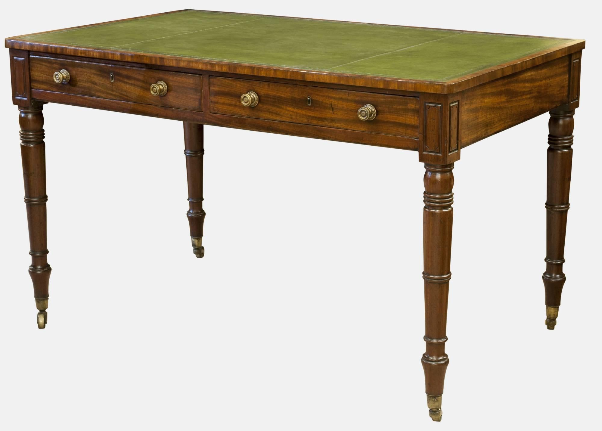 A good Regency mahogany library table having a green leather insert and two deep drawers (dummied on reverse). Raised on turned legs to original castors, circa 1810.