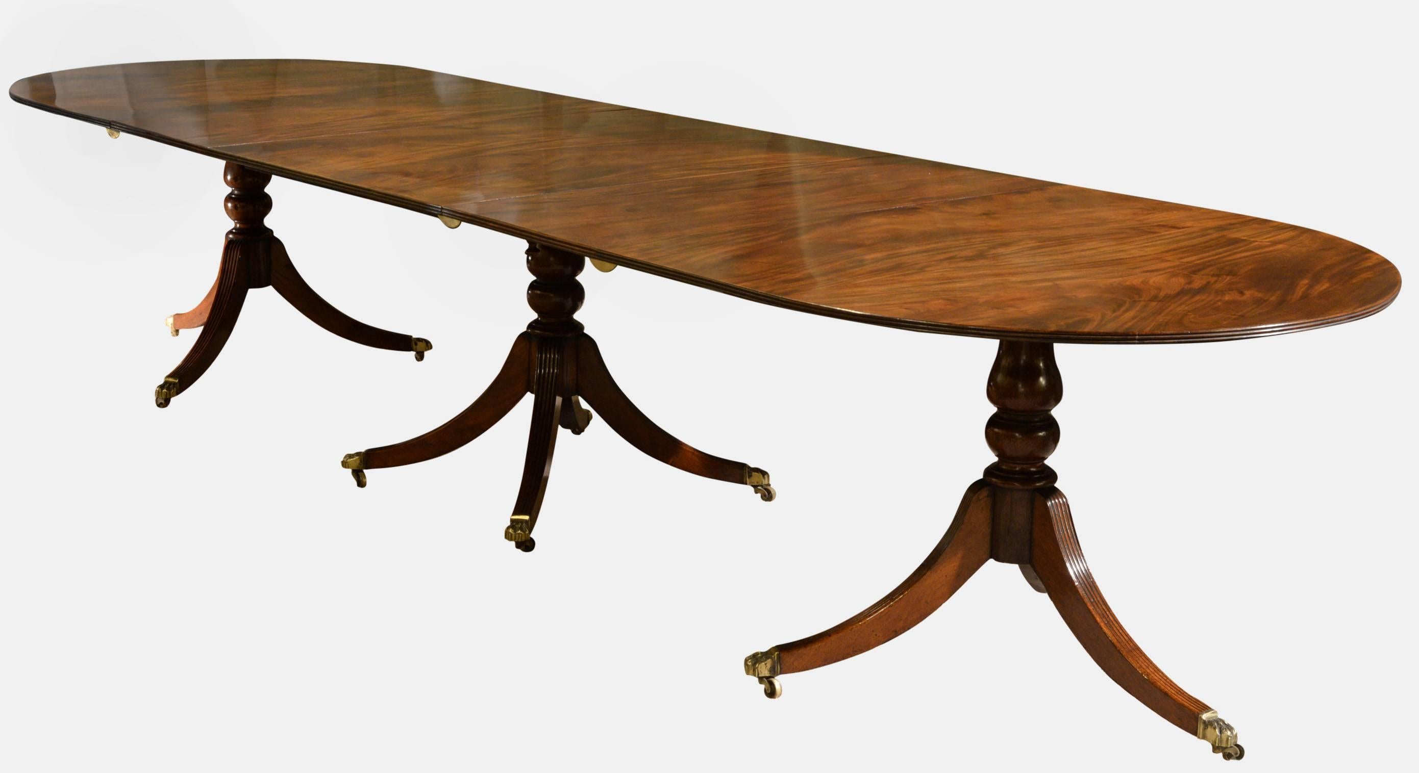 A fine early 19th century mahogany three pillar dining table of rich colour and figure. Raised on baluster turned columns to reeded splay legs and claw castors. Extending with 2 leaves to seat 14 plus, 

circa 1820.

74cm (29.1