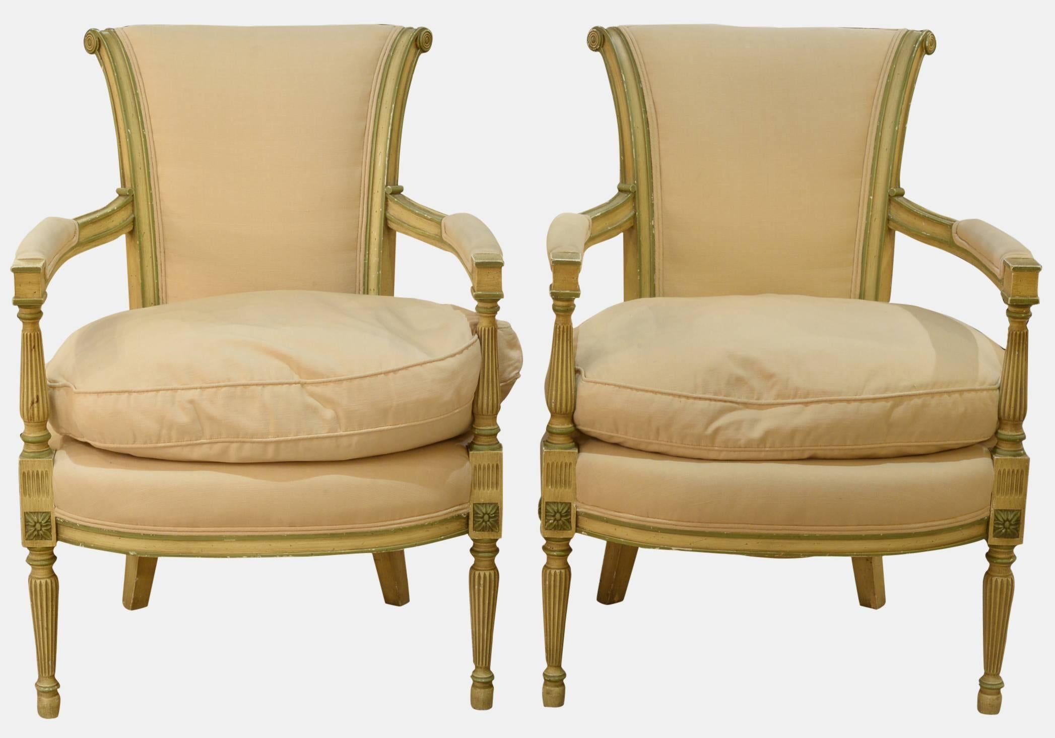 A pair of cream and pale green painted Directoire style elbow chairs with squab cushions,

circa 1920.
Measures:
86cm (33.9