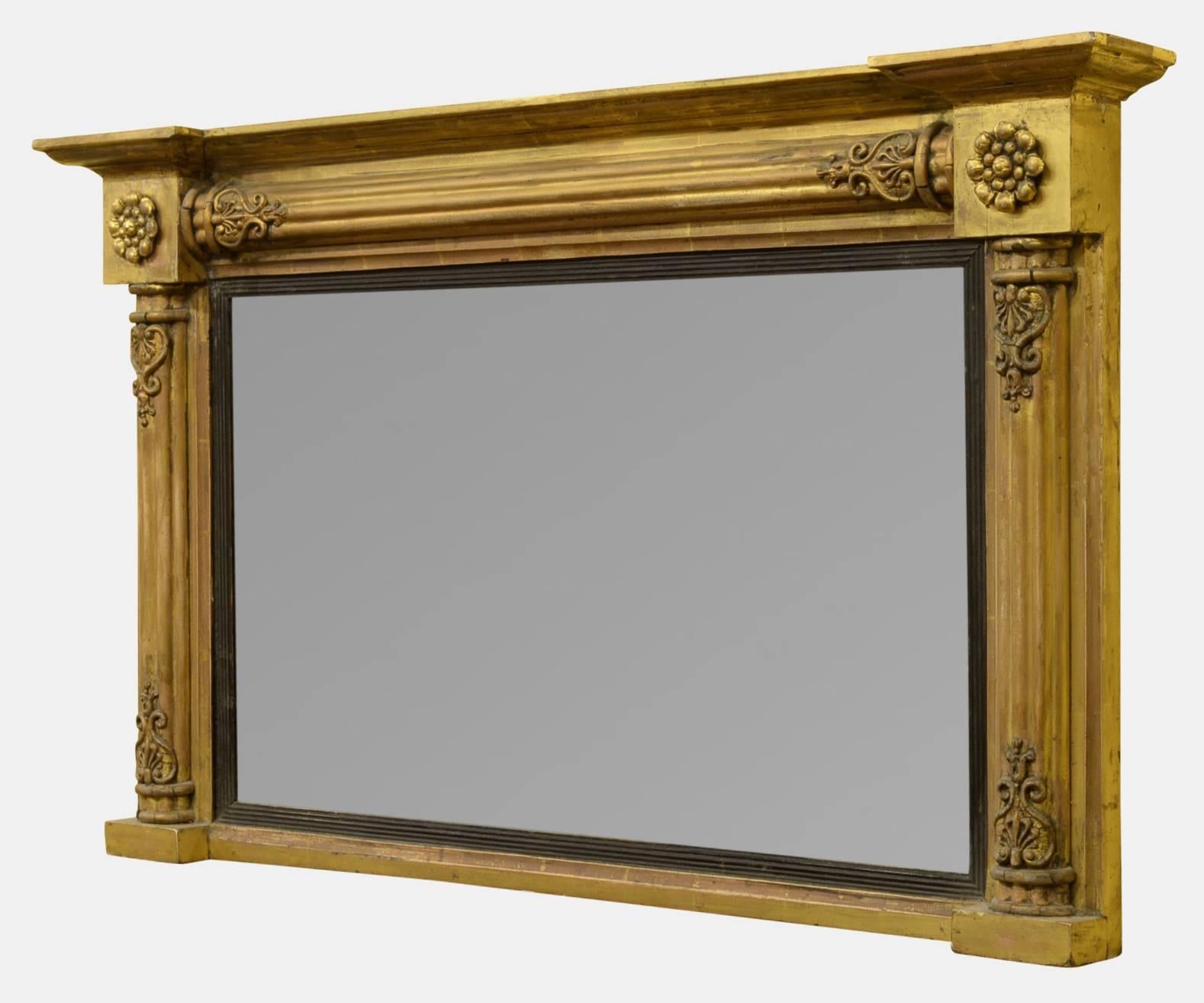 A William IV gilded overmantel mirror with lobed column decoration and rosettes to corners, with original plate,

circa 1835.

