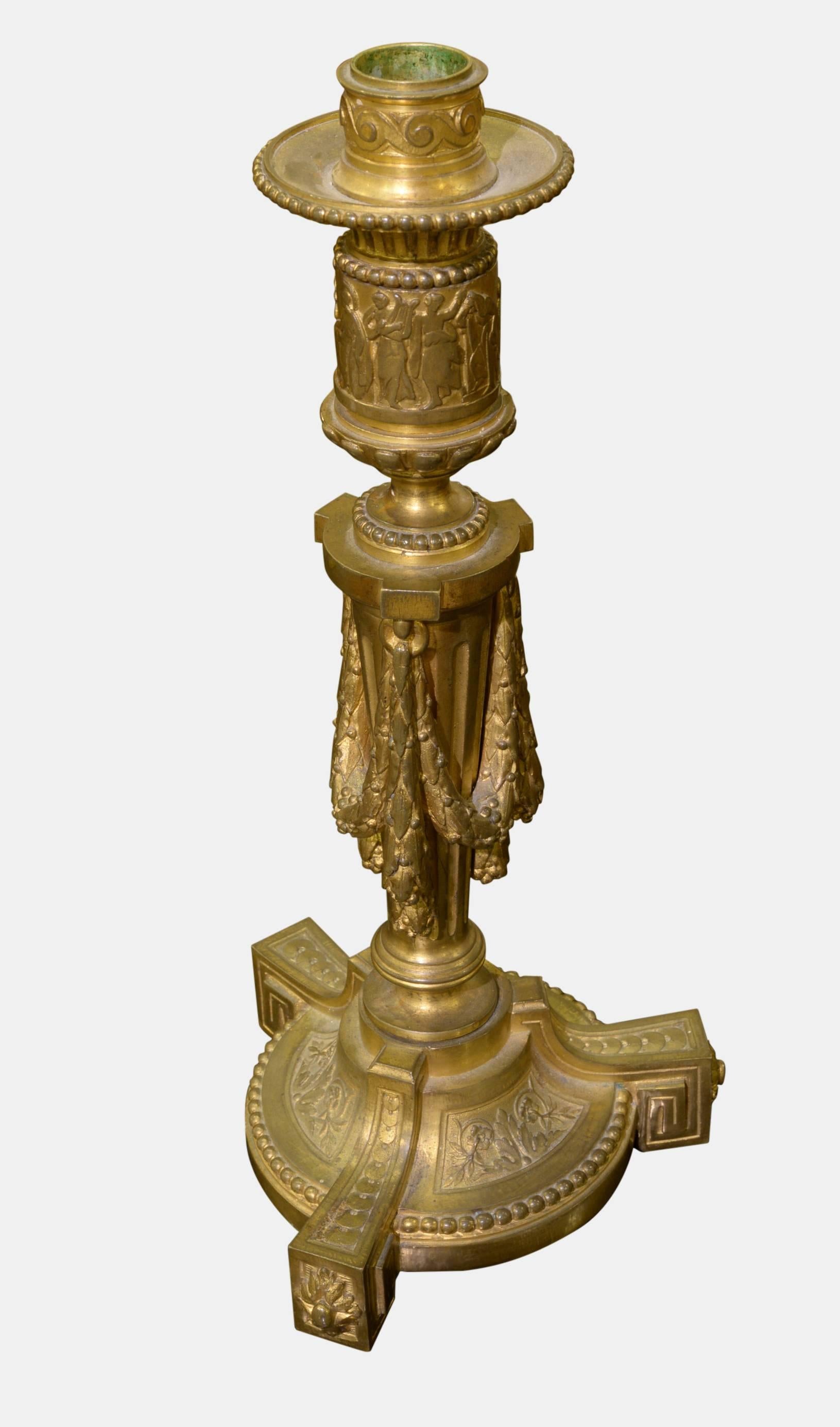 A fine pair of French Louis XVI gilt bronze candlesticks in neoclassical style,

circa 1880.
