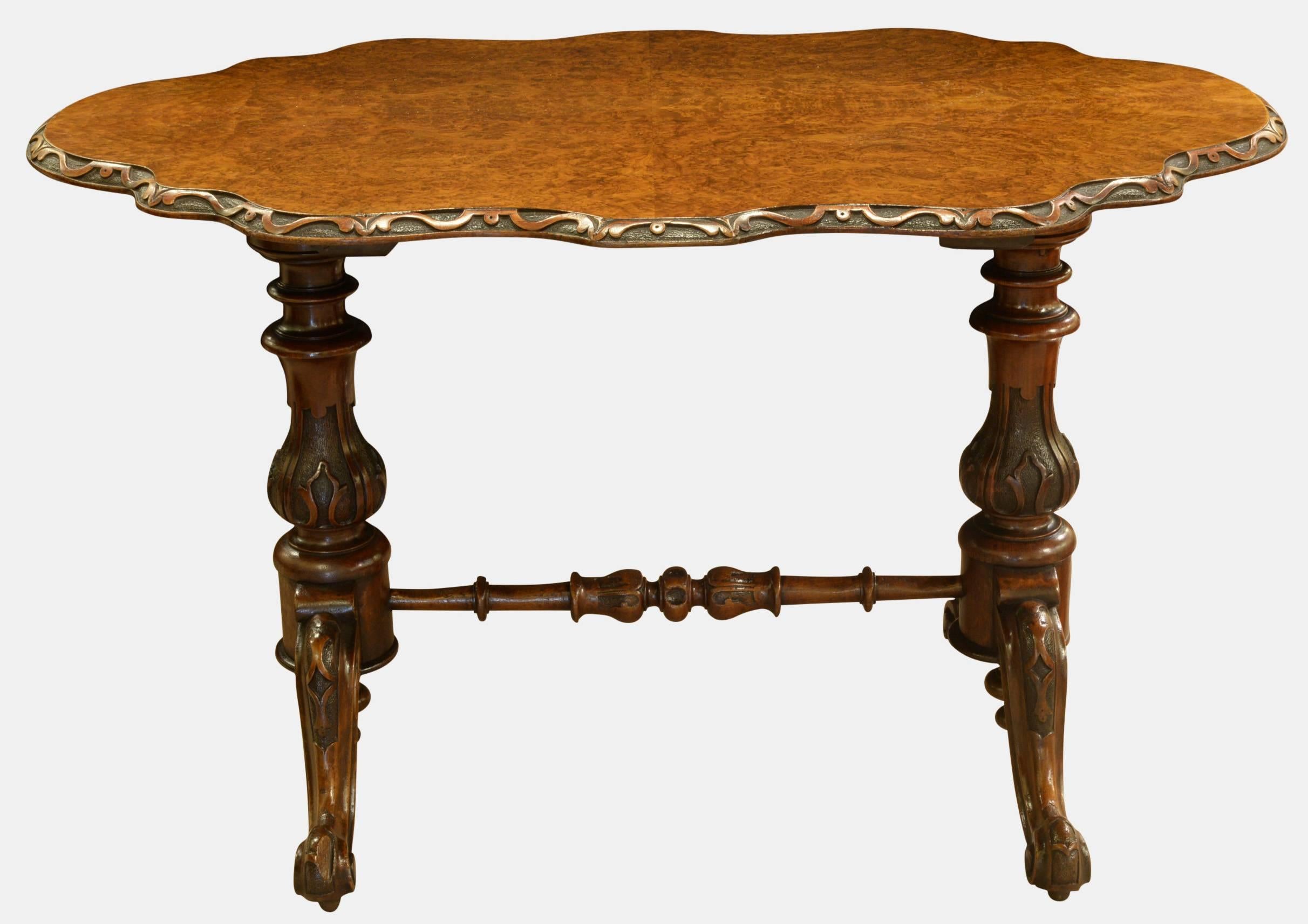 A burr walnut, shaped top Victorian stretcher table. Standing on turned supports and with cabriole legs,

circa 1870.