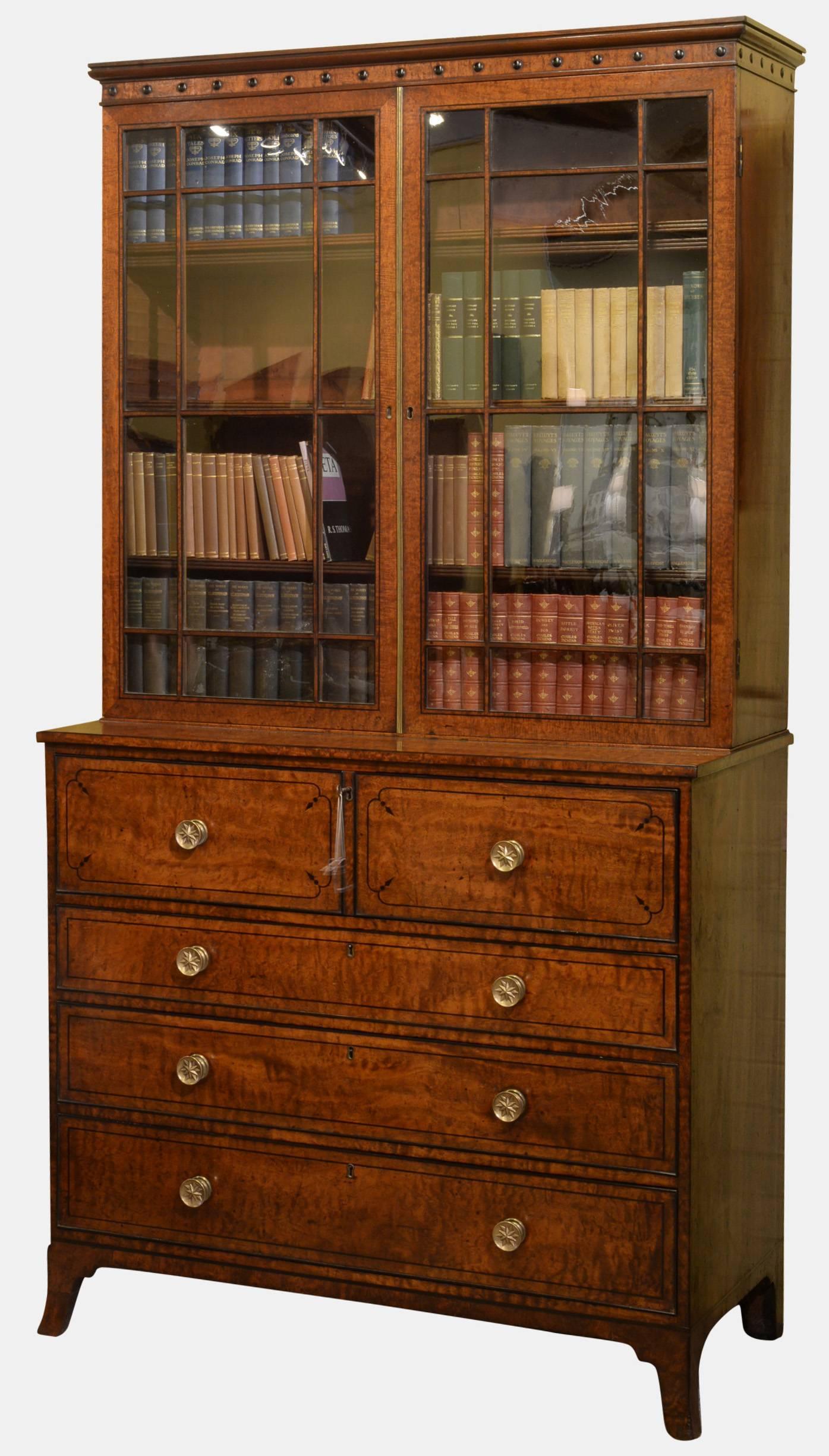 A fine English Regency mahogany secretaire bookcase of superb figure and colour. Inlaid throughout with ebony, the upper case with adjustable shelves, 

circa 1810.