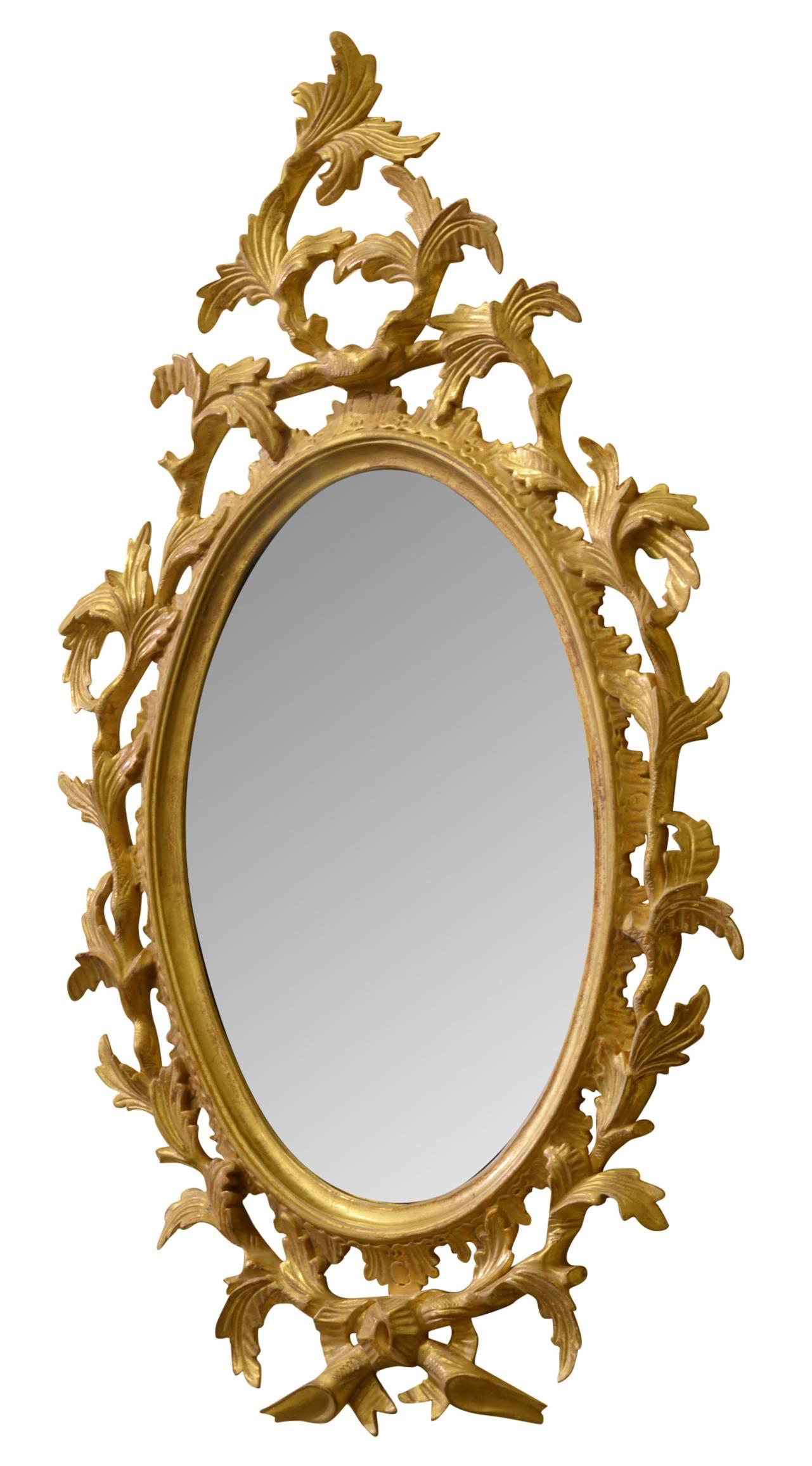 Antique George III style Rococo carved giltwood small mirror,

circa 1900.