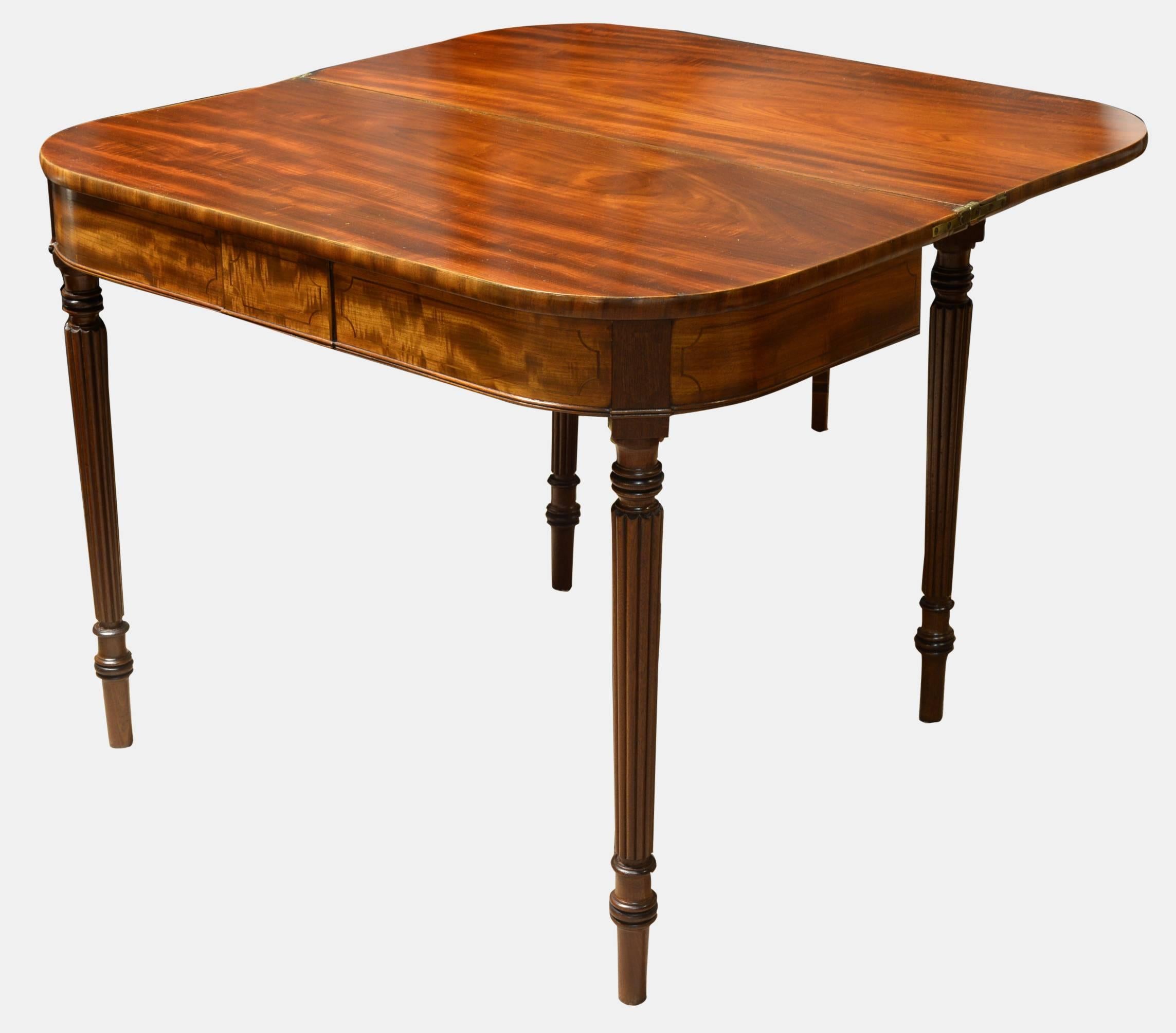 A Regency mahogany tea table on reeded supports.