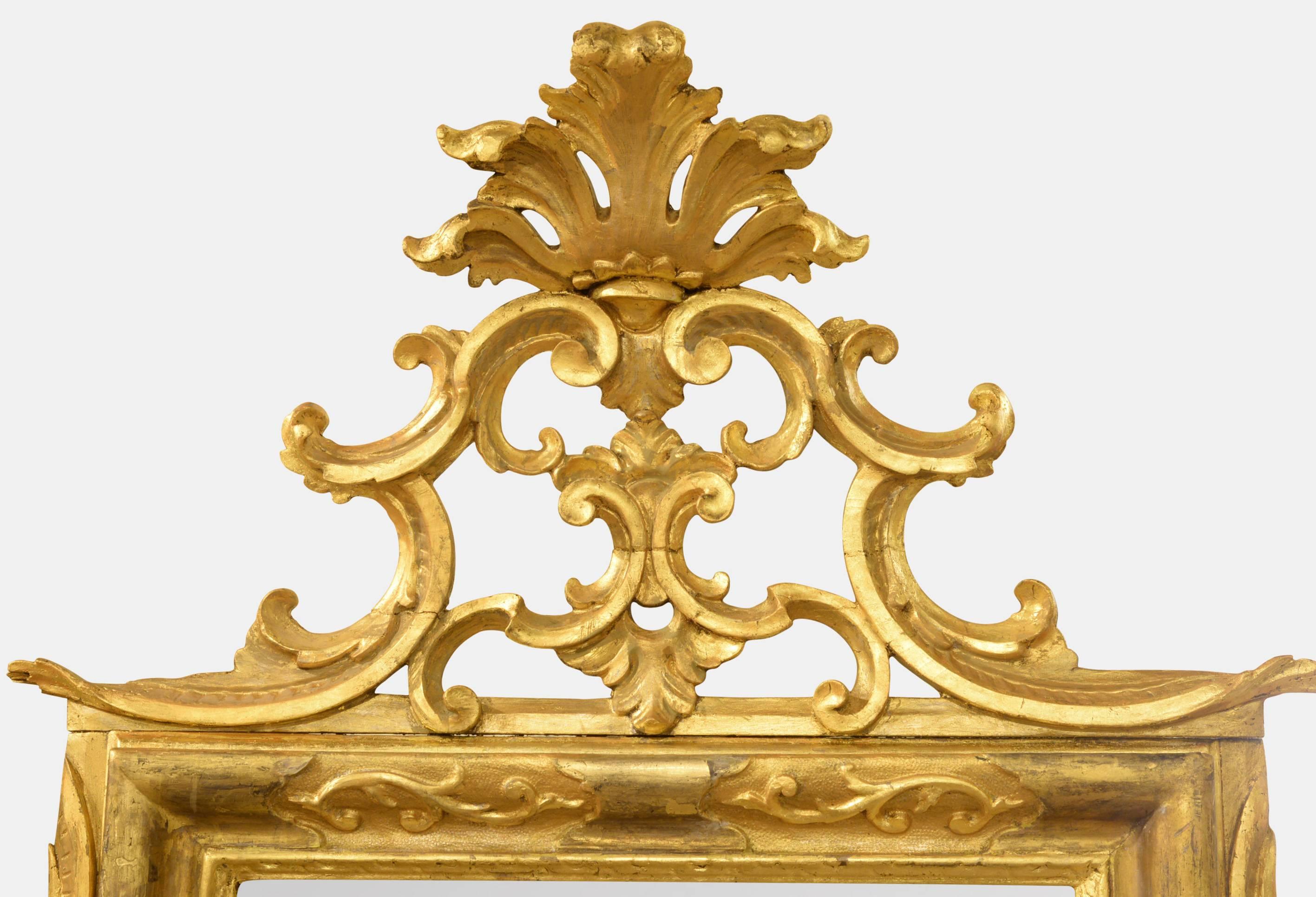 An Italian gilded rectangular mirror with decorative cresting,

circa 1800.
