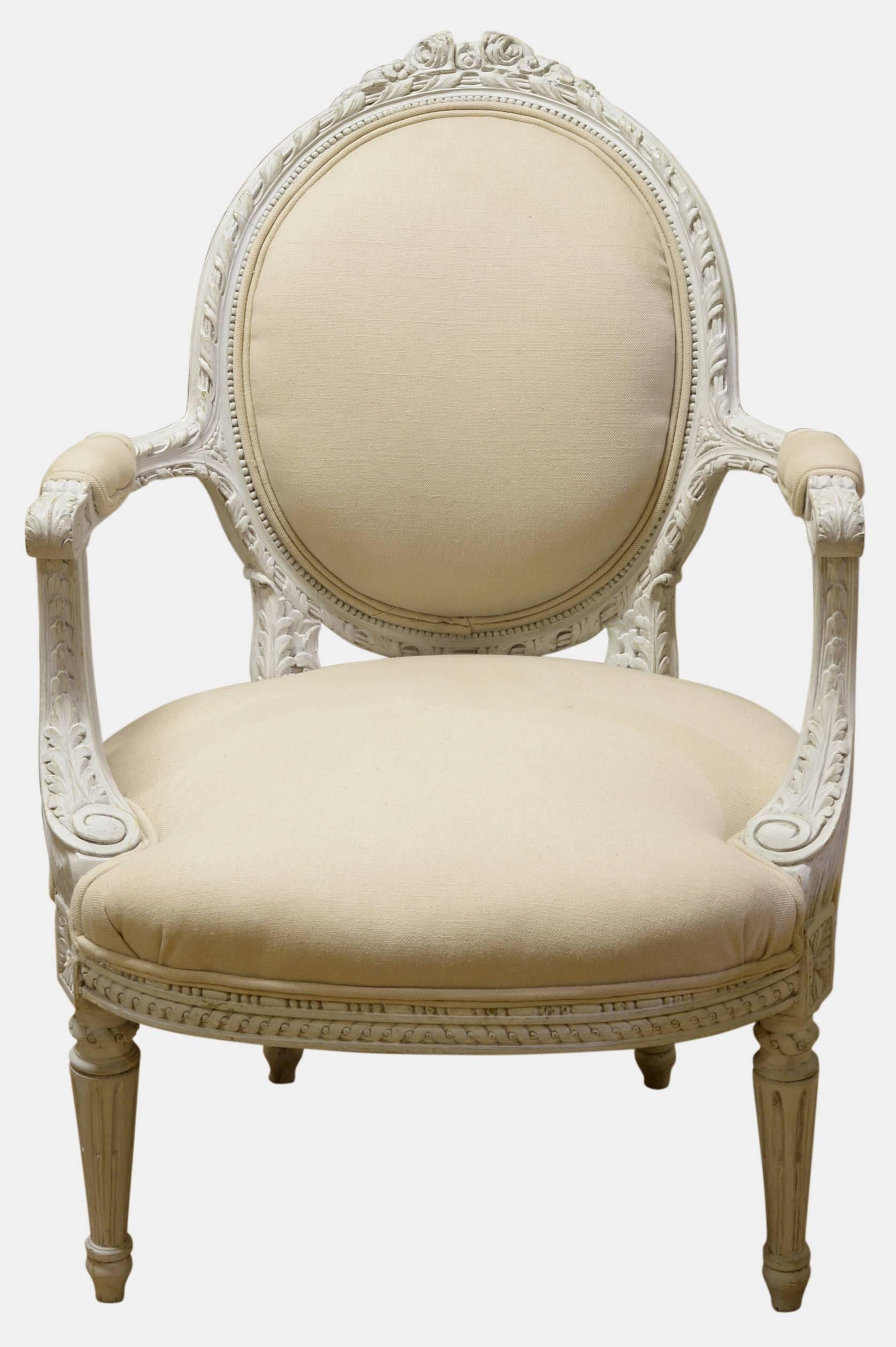 A pair of French oval back open arm occasional chairs. Newly re-upholstered in cream linen,

circa 1930s.