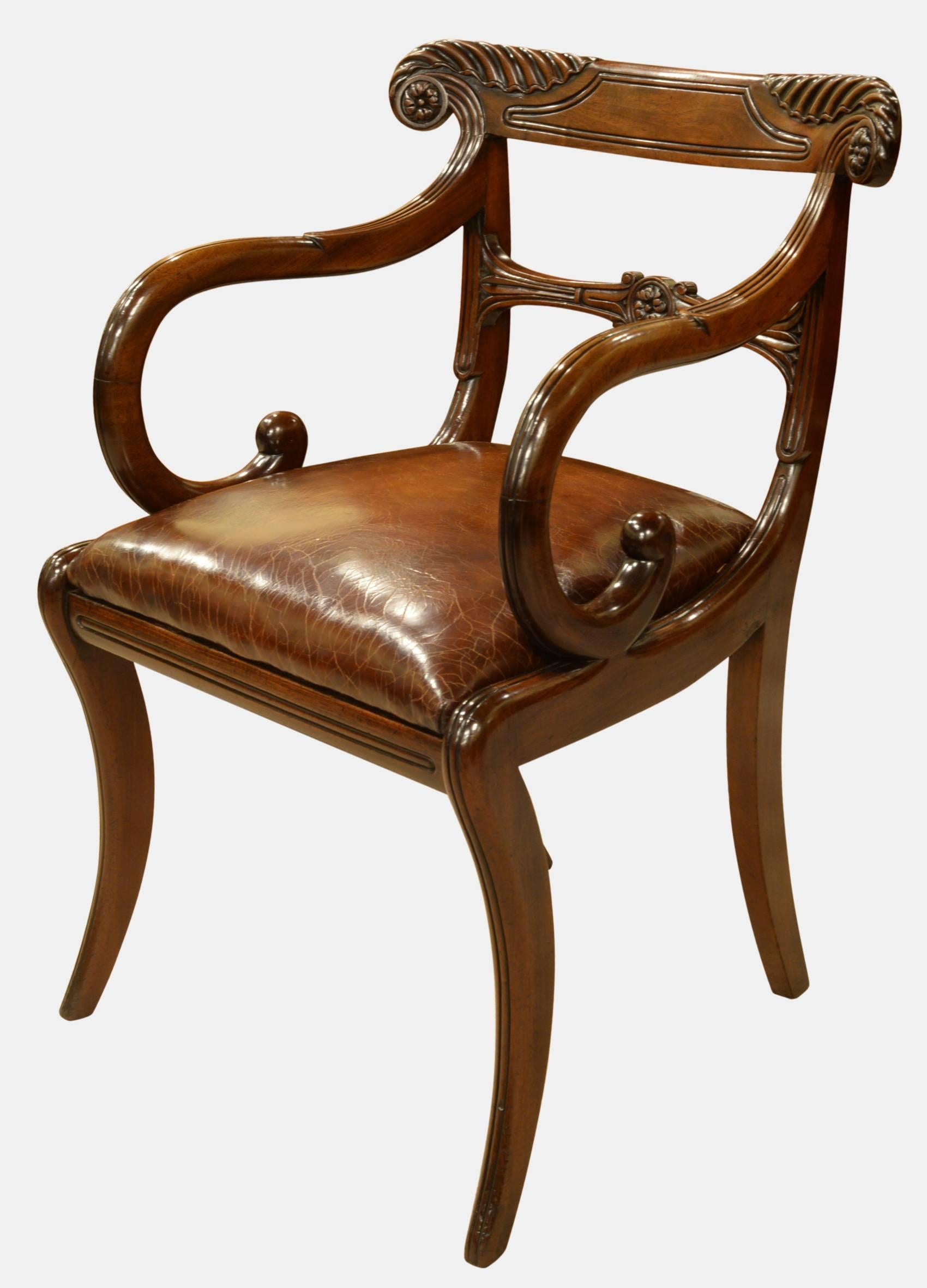 A fine pair of Regency period carved mahogany carver chairs of trafalagan back design with leather seats.

circa 1810.