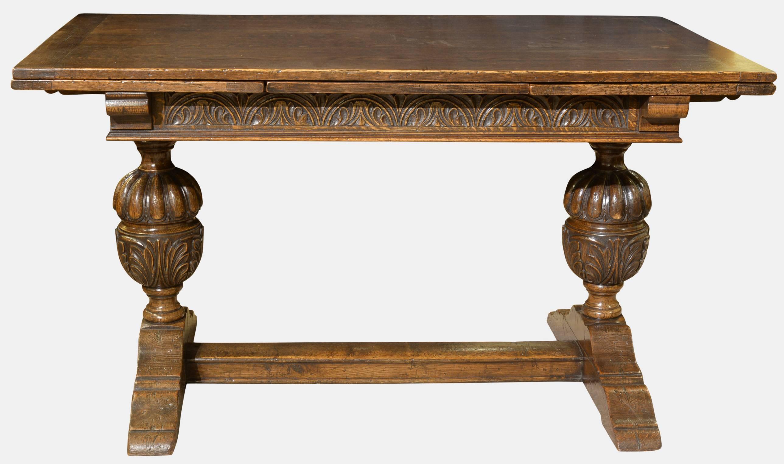 A very good carved oak draw leaf table in the Elizabethan style, with cup and cover end supports,

circa 1900.
