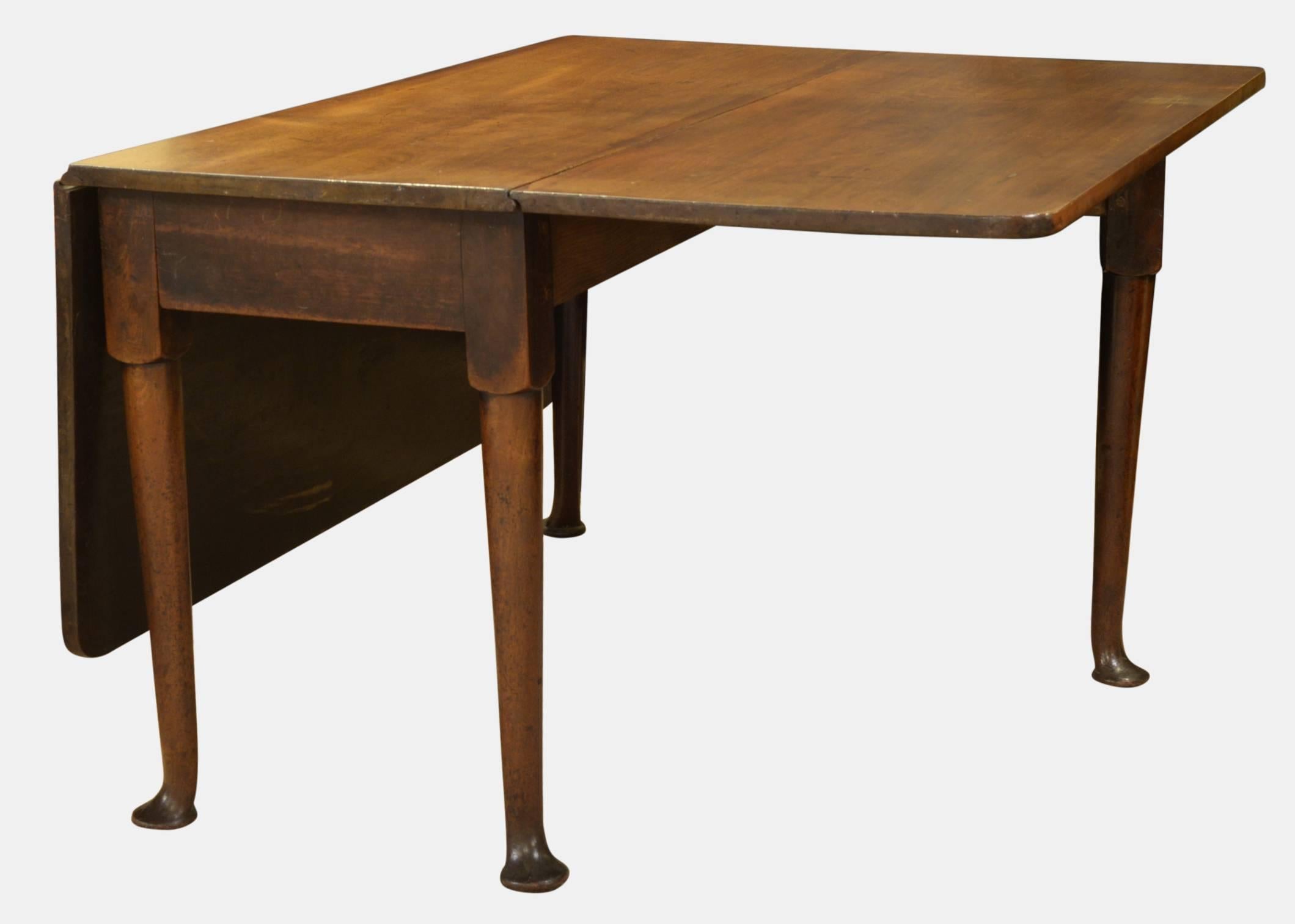 A George III mahogany drop-leaf dining table standing on straight turned legs with pad feet,

circa 1780.