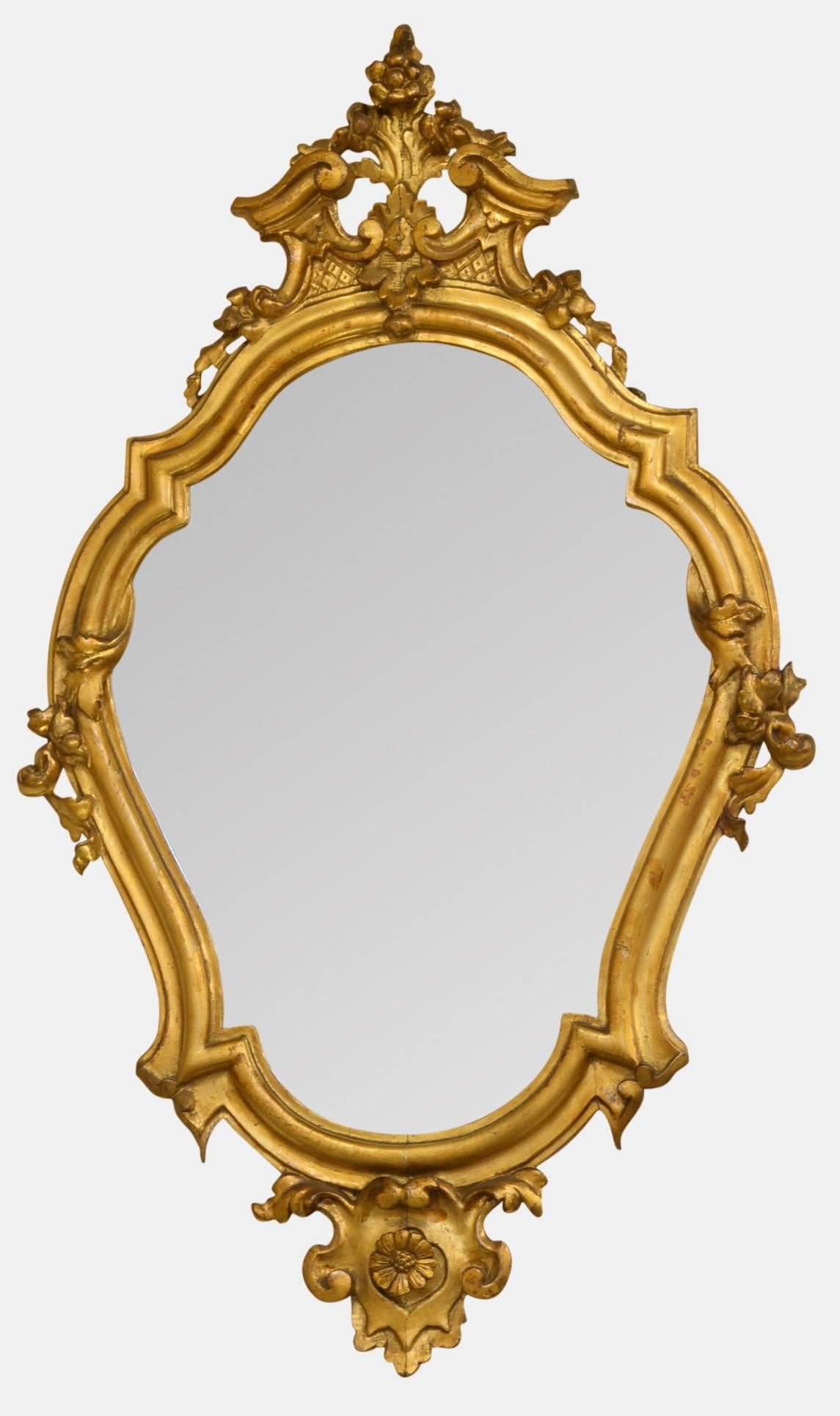 A pair of Italian early 19th century shaped, gilded girandole mirrors.