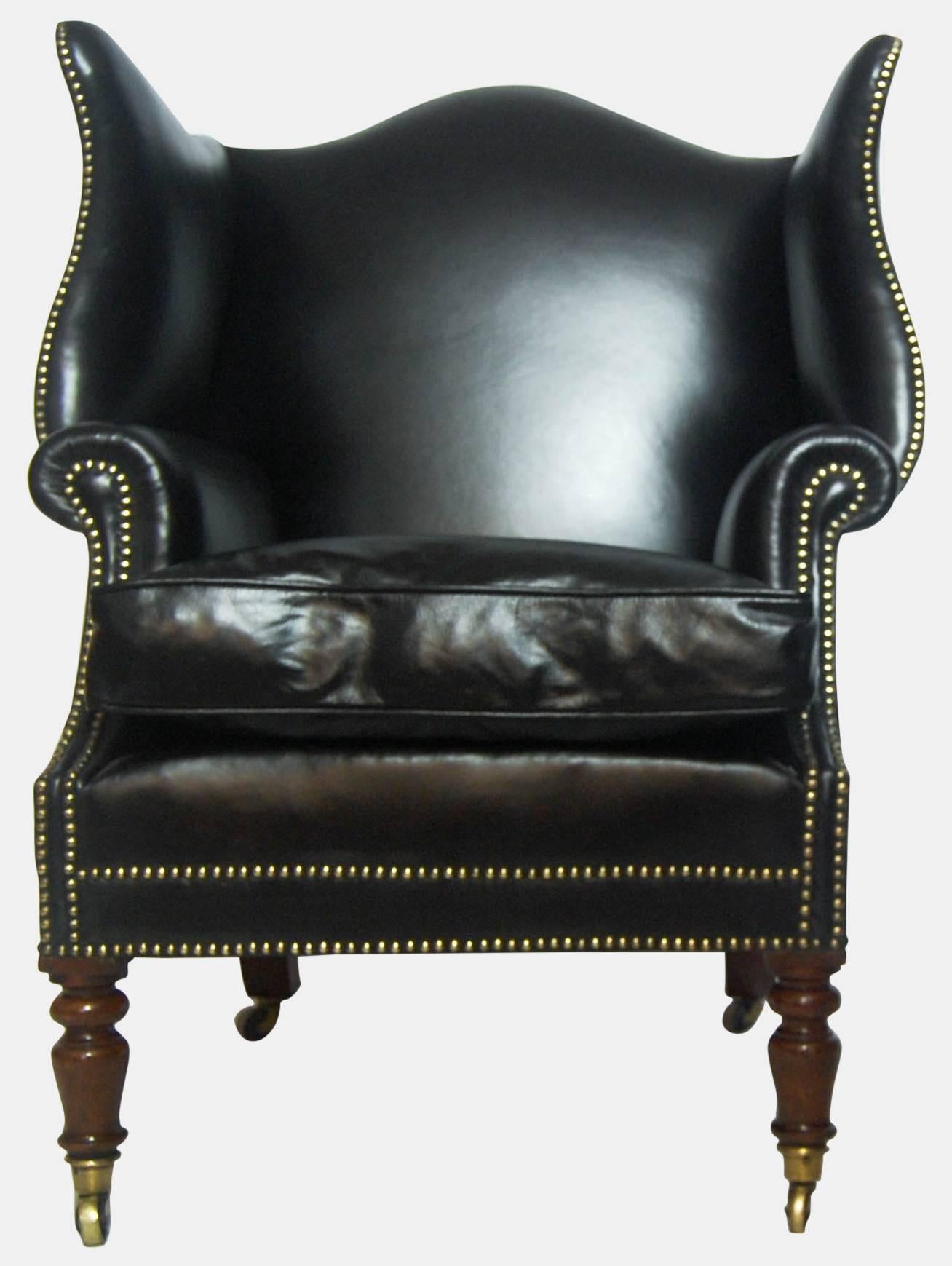 Early 19th century mahogany and leather wingback library chair.
