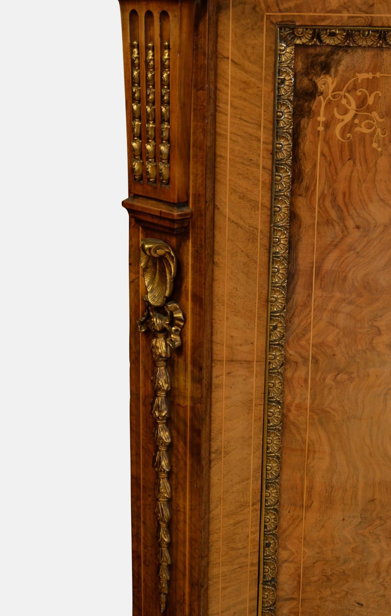 An exhibition quality Victorian burr walnut two-door cabinet with brass gallery and mountings.