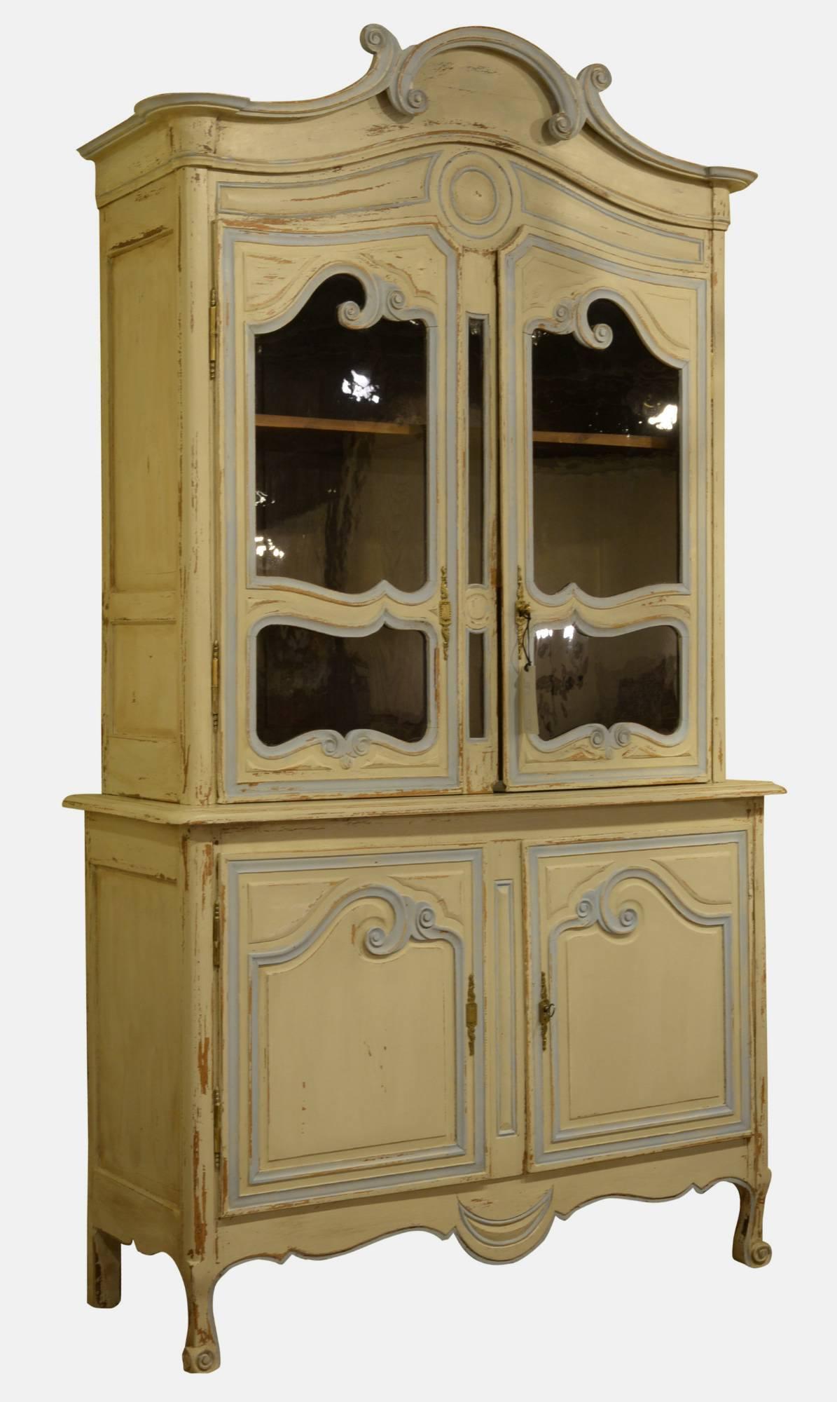 Late 19th French armoire with glazed doors above a two-door cupboard.