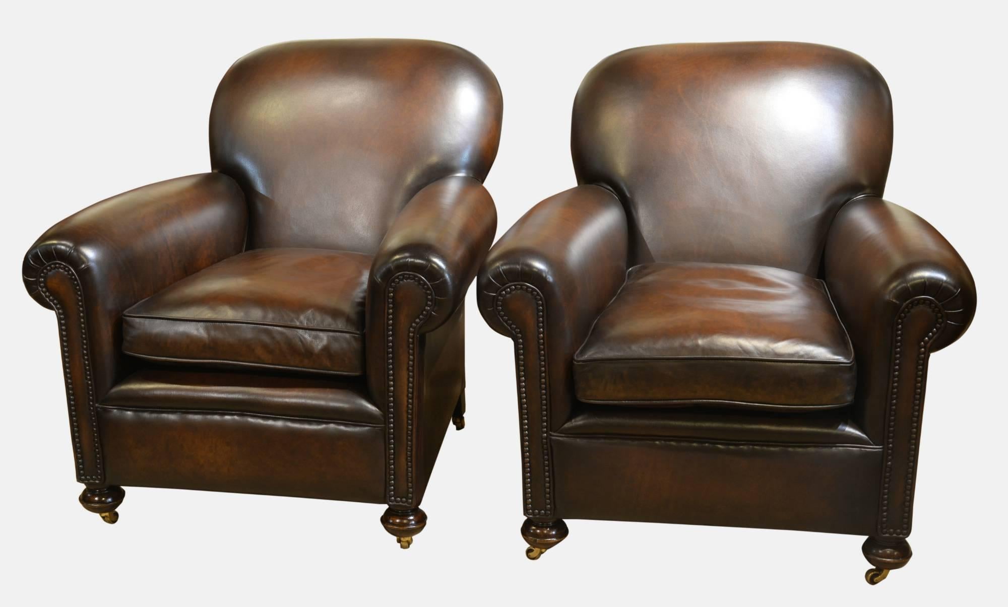 Pair of leather club chairs. Reupholstered in antique hide,

circa 1920.