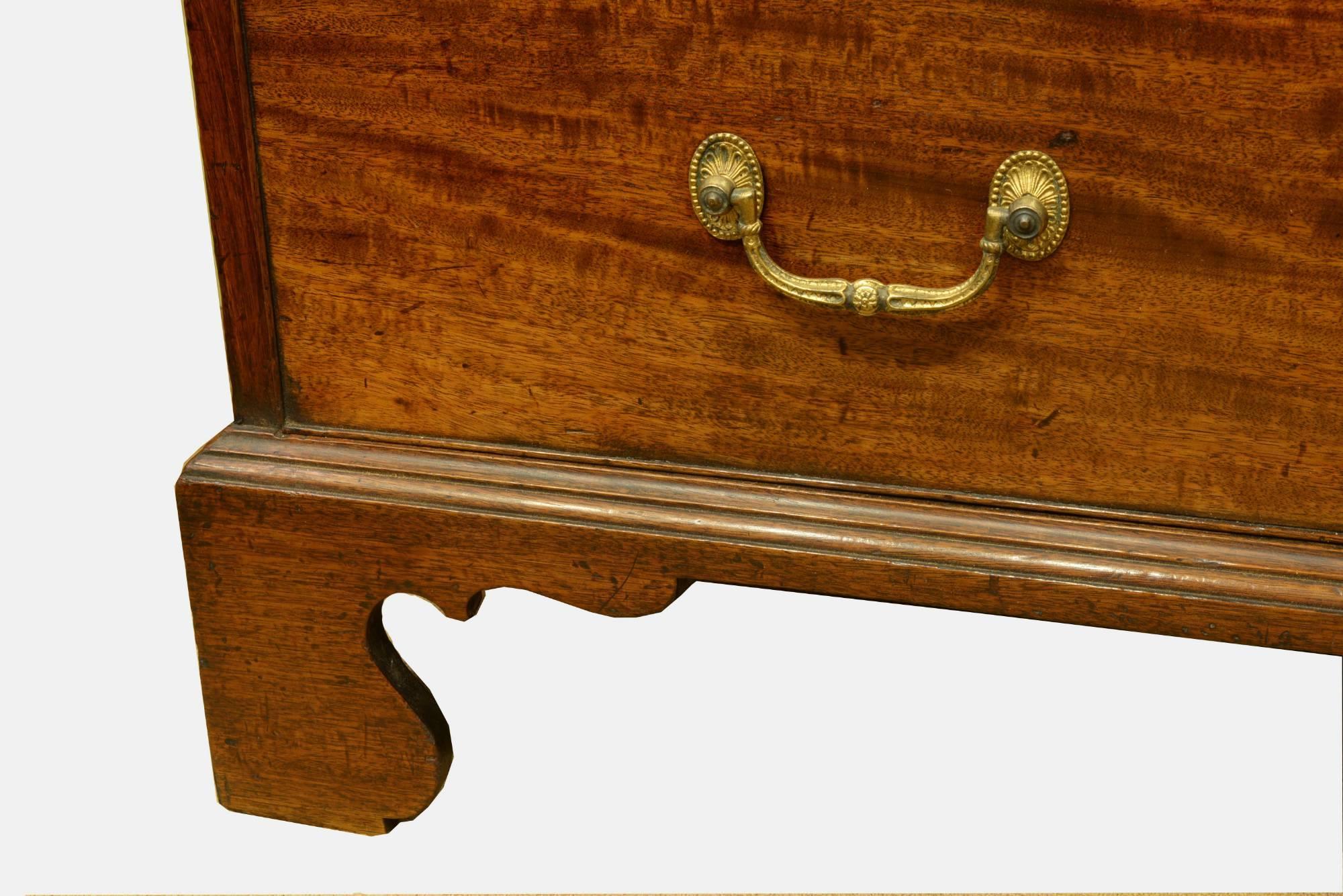 A George III mahogany tallboy or chest on chest. With dentil cornice, blind fret frieze, finely figured drawers fronts and original gilt brasses. Original feet, attractively narrow proportion,

circa 1780.