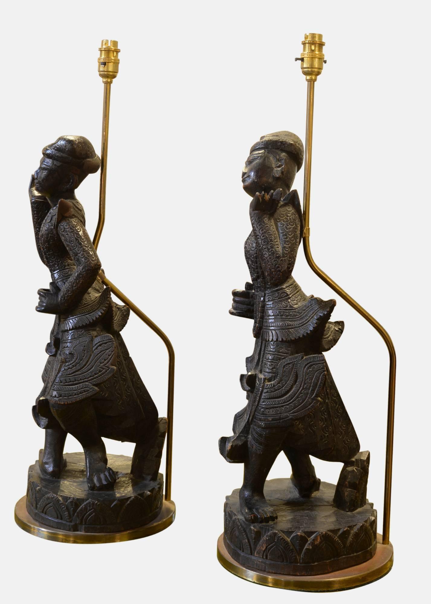 A pair of early 20th century carved Burmese wooden dancing figures re-wired as table lamps.