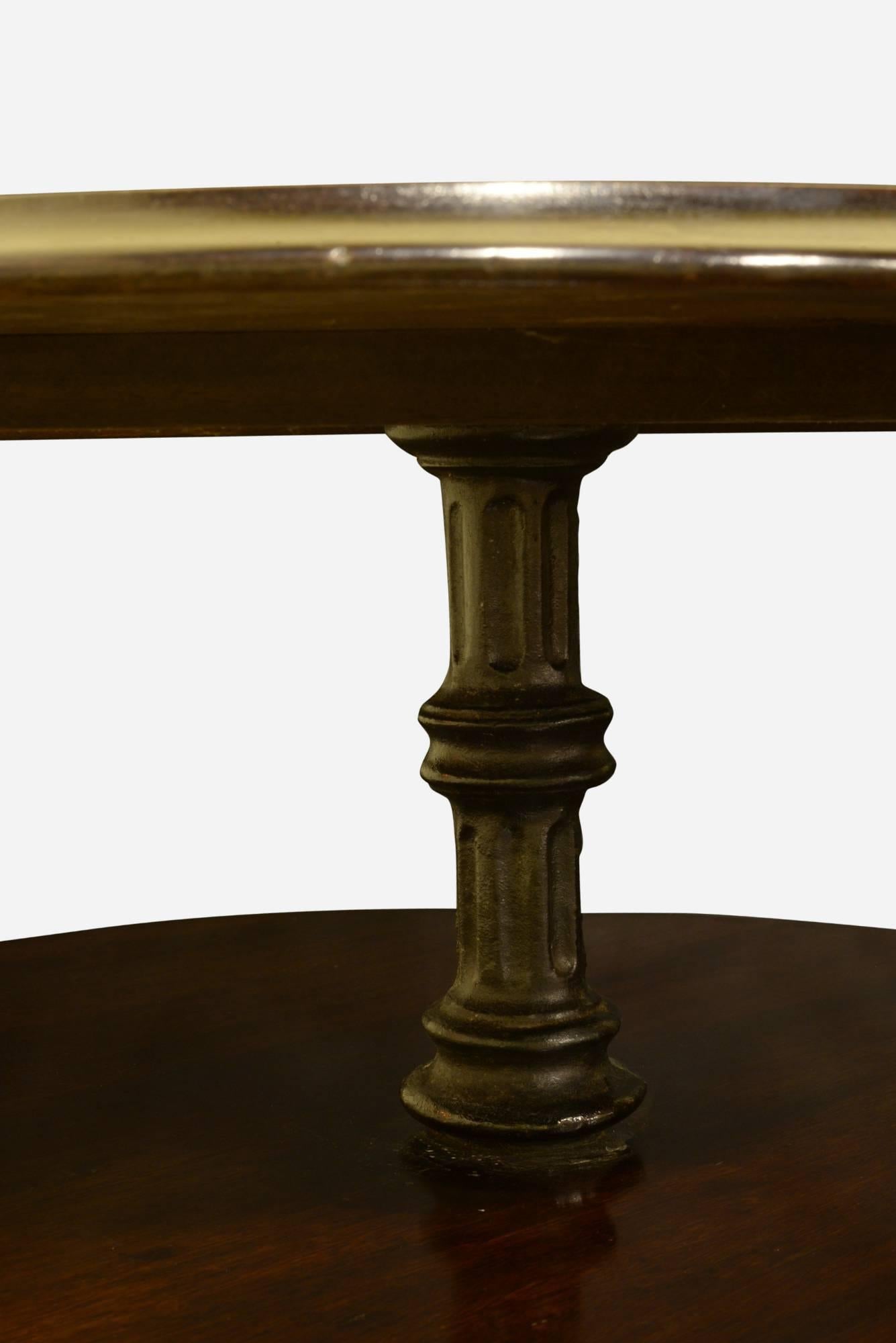 A two-tier mahogany pub table with cast iron base,

circa 1900.
 