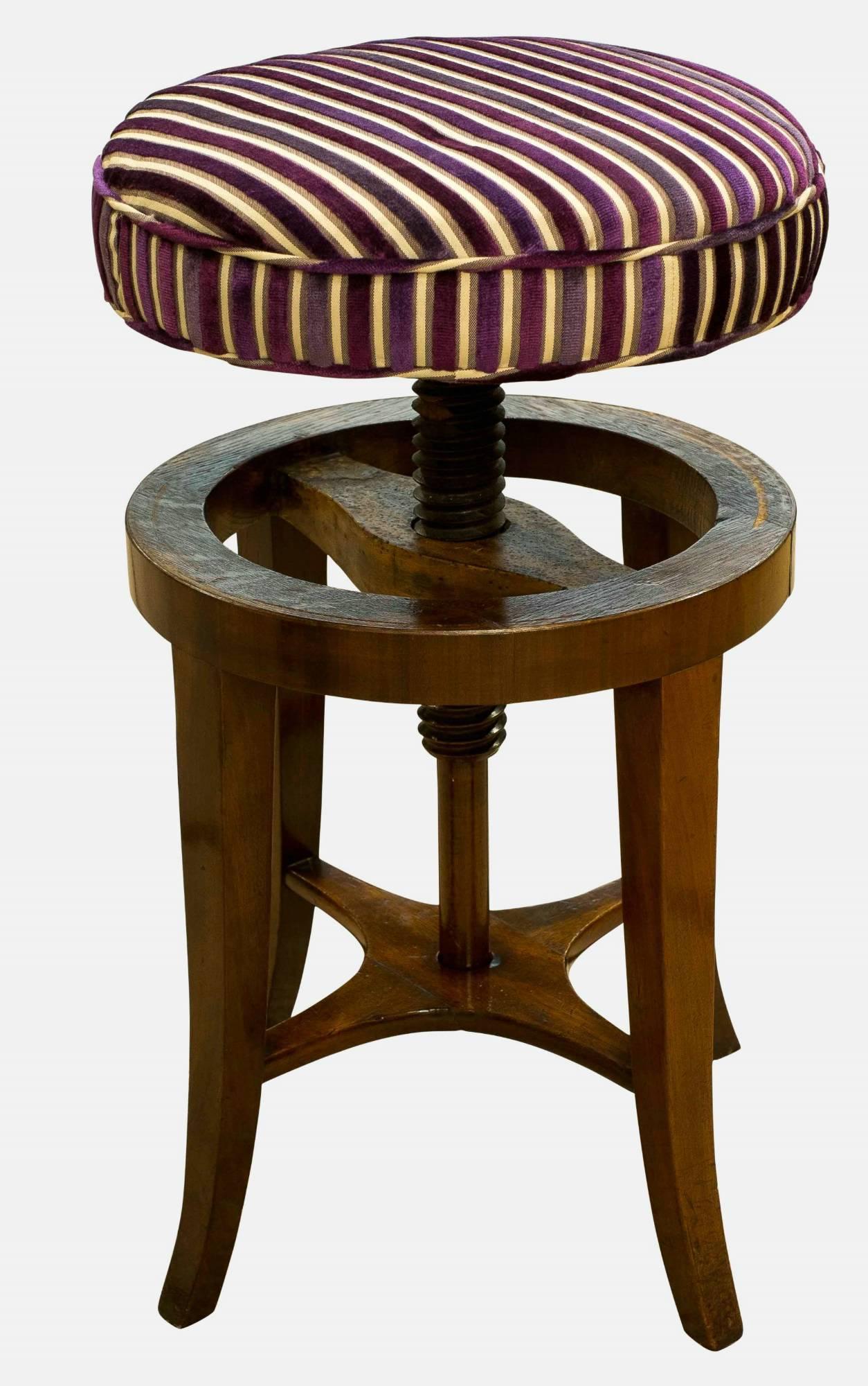 A Regency mahogany revolving music stool raised on sabre supports

circa 1815.