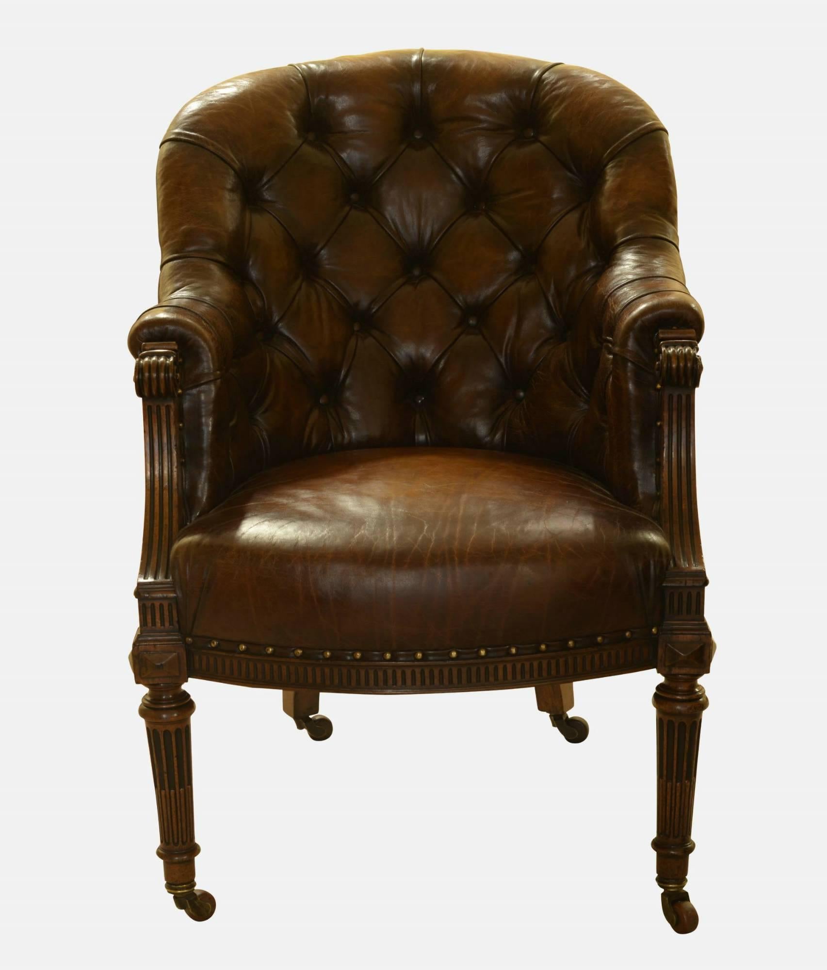 A pair of stunningly carved Regency mahogany leather Liberty chairs.