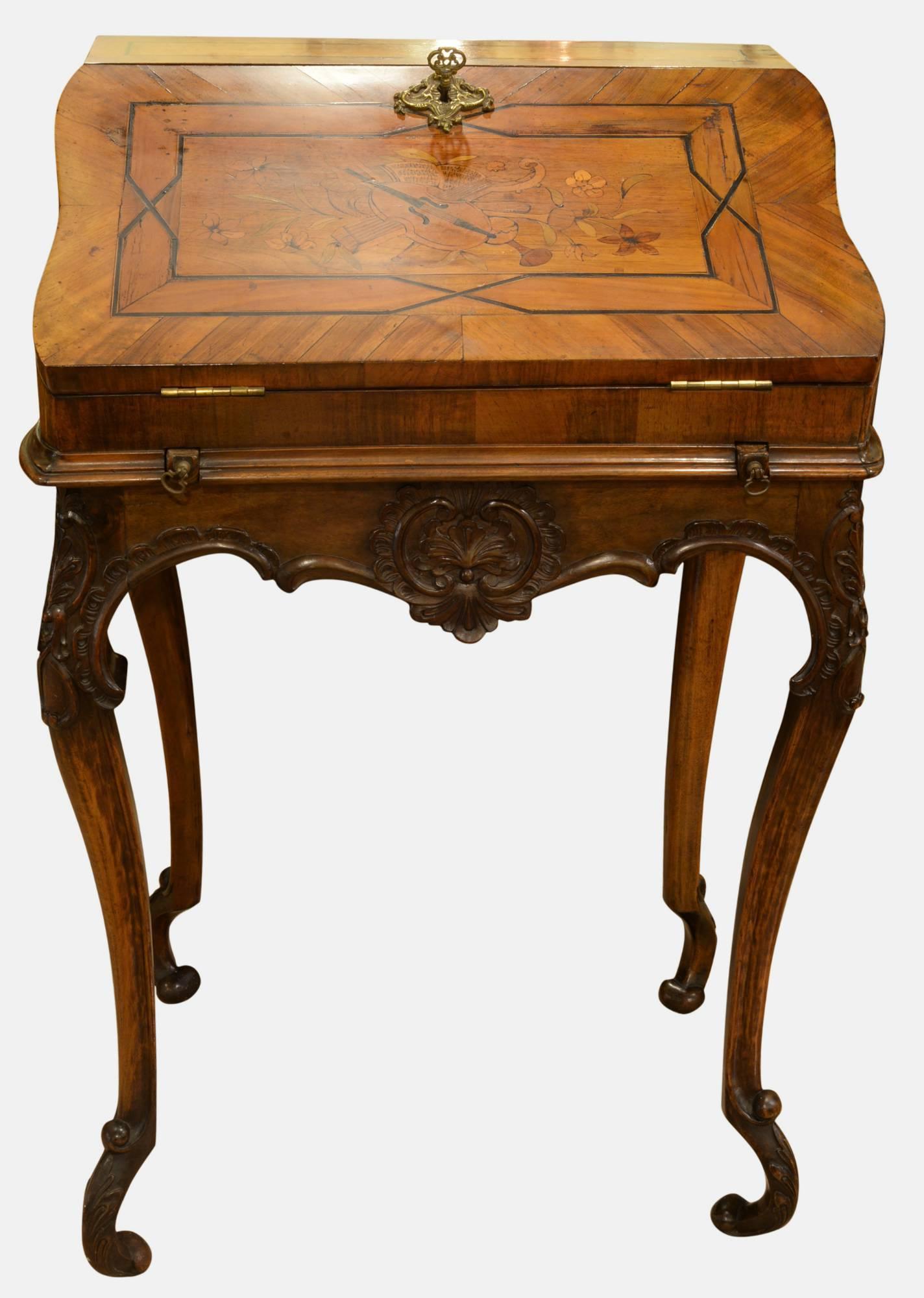 A 19th century mahogany and walnut ladies bureau with a marquetry trophy of musical instruments to the fall. Supported on shaped legs,

circa 1880.
 