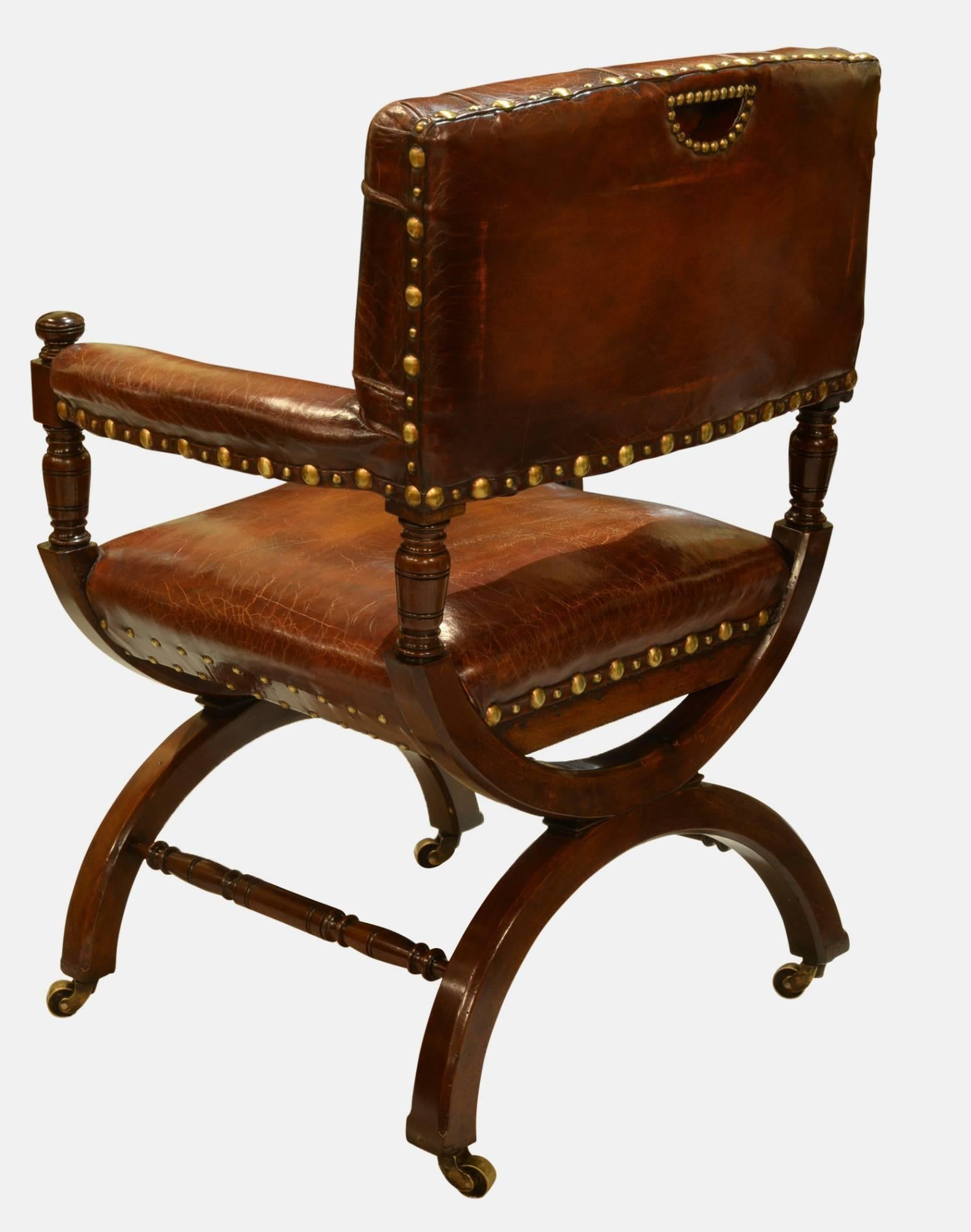 A stunning pair of 19th Century mahogany X-frame library chairs in hand dyed leather after a Gillows design,

circa 1890.