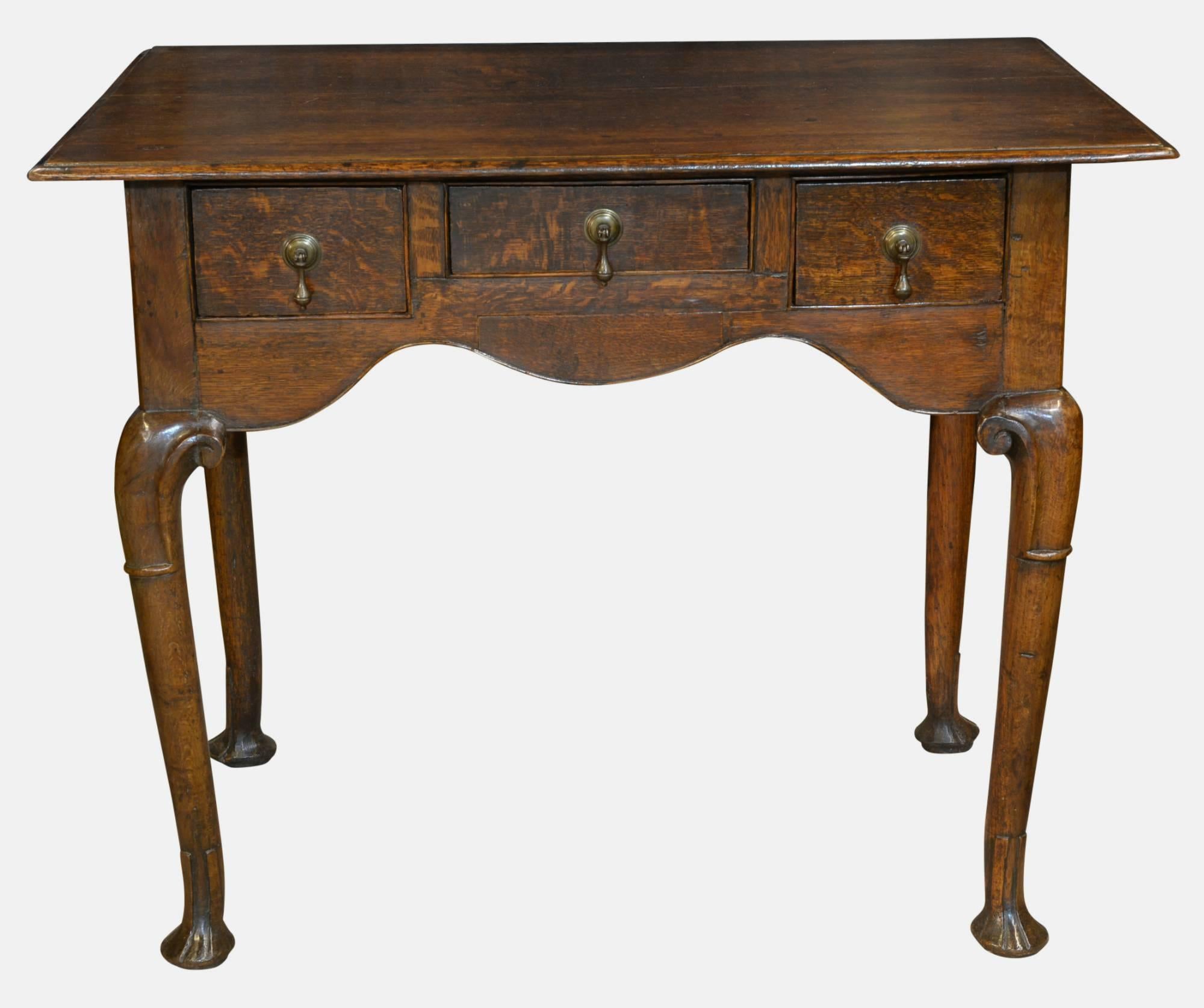 An 18th century, oak lowboy of three drawers. On turned legs with lappet feet,

circa 1770.