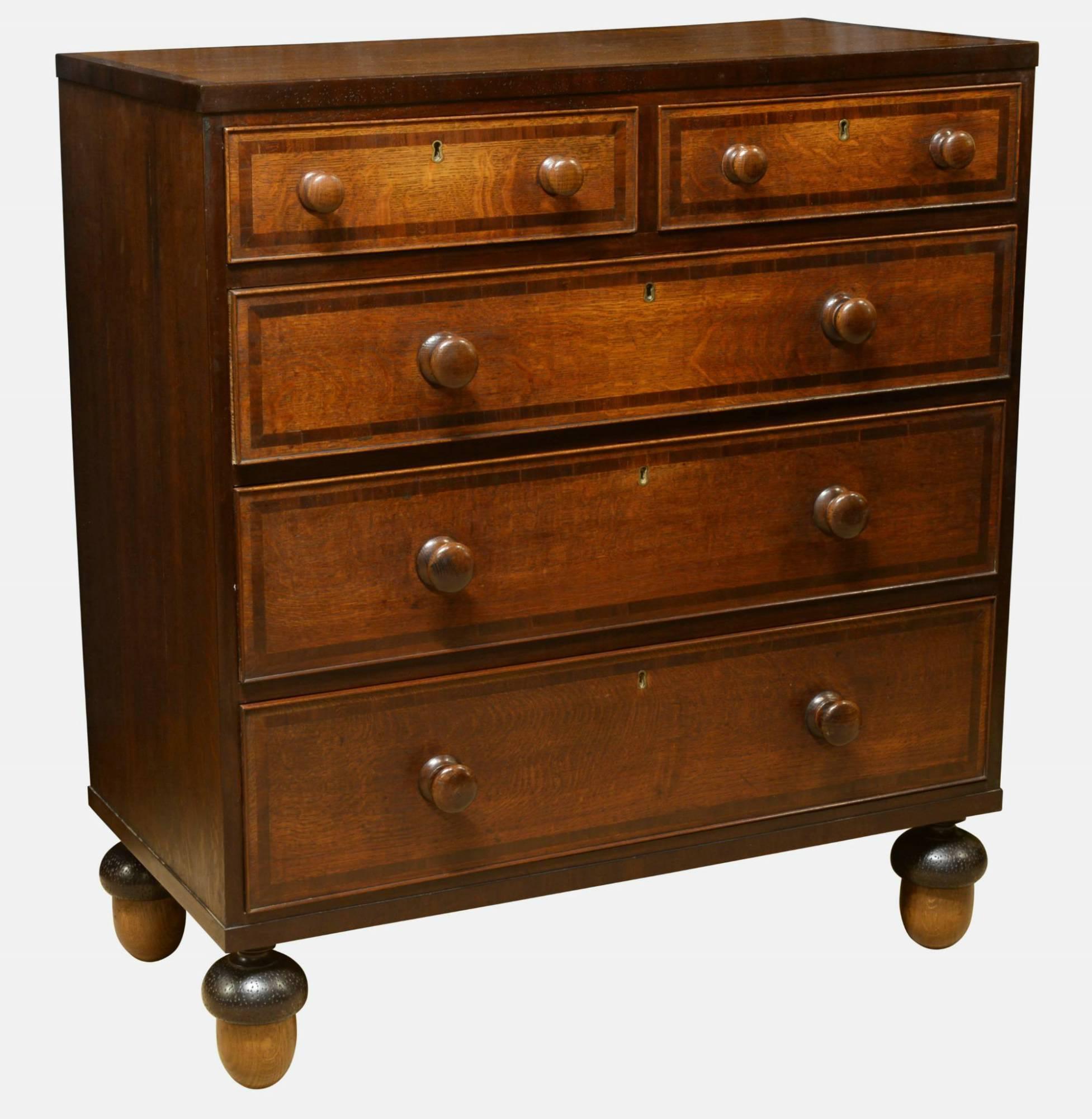 A George III oak chest of drawers banded in mahogany, with original turned wooden handles. On later turned acorn feet,
 
circa 1780.