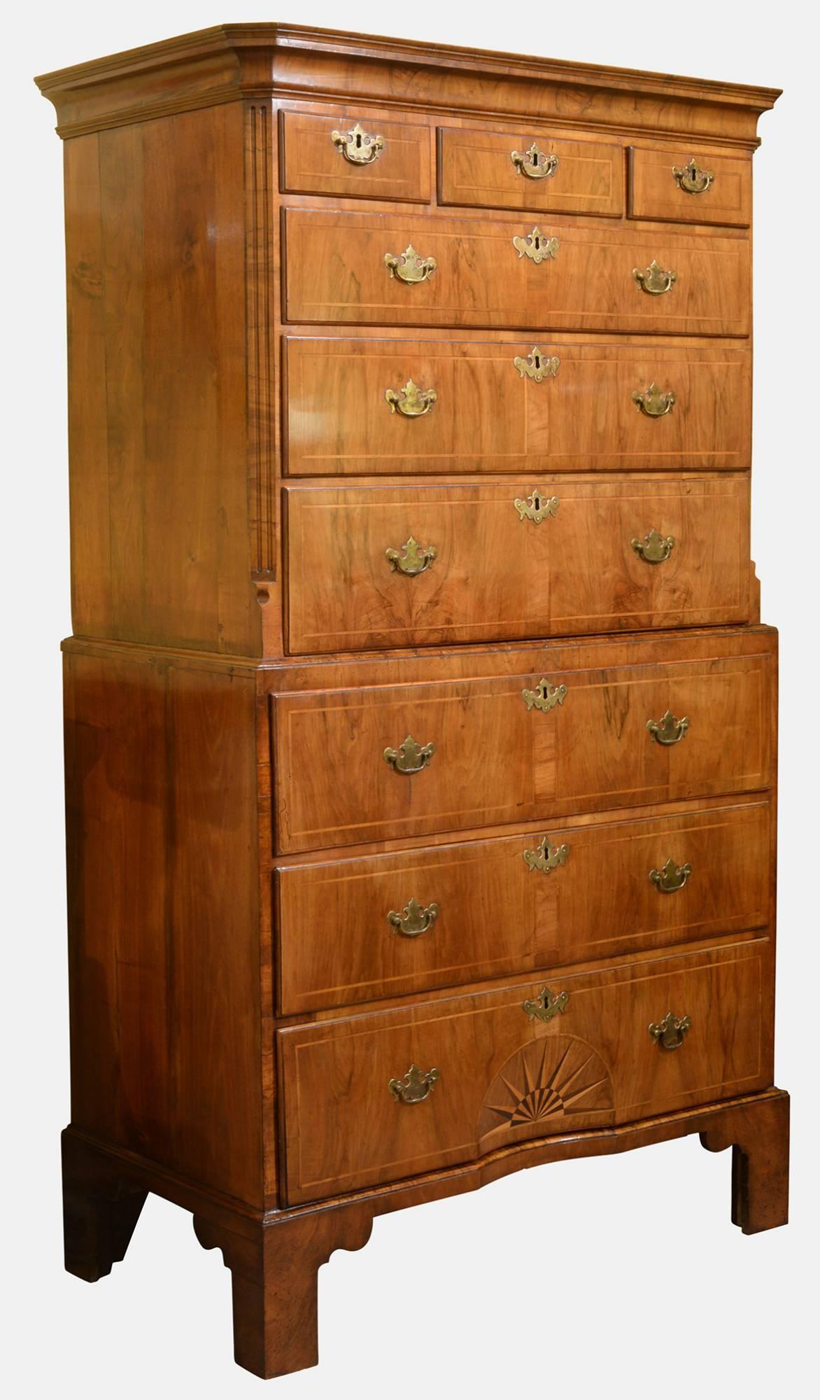A fine and rare George II walnut secretaire chest on chest with fluted canted corners. The drawer fronts inlaid with a narrow walnut band, the bottom drawer further inlaid with a concave sunburst. The writing drawer stepped and shaped, fitted