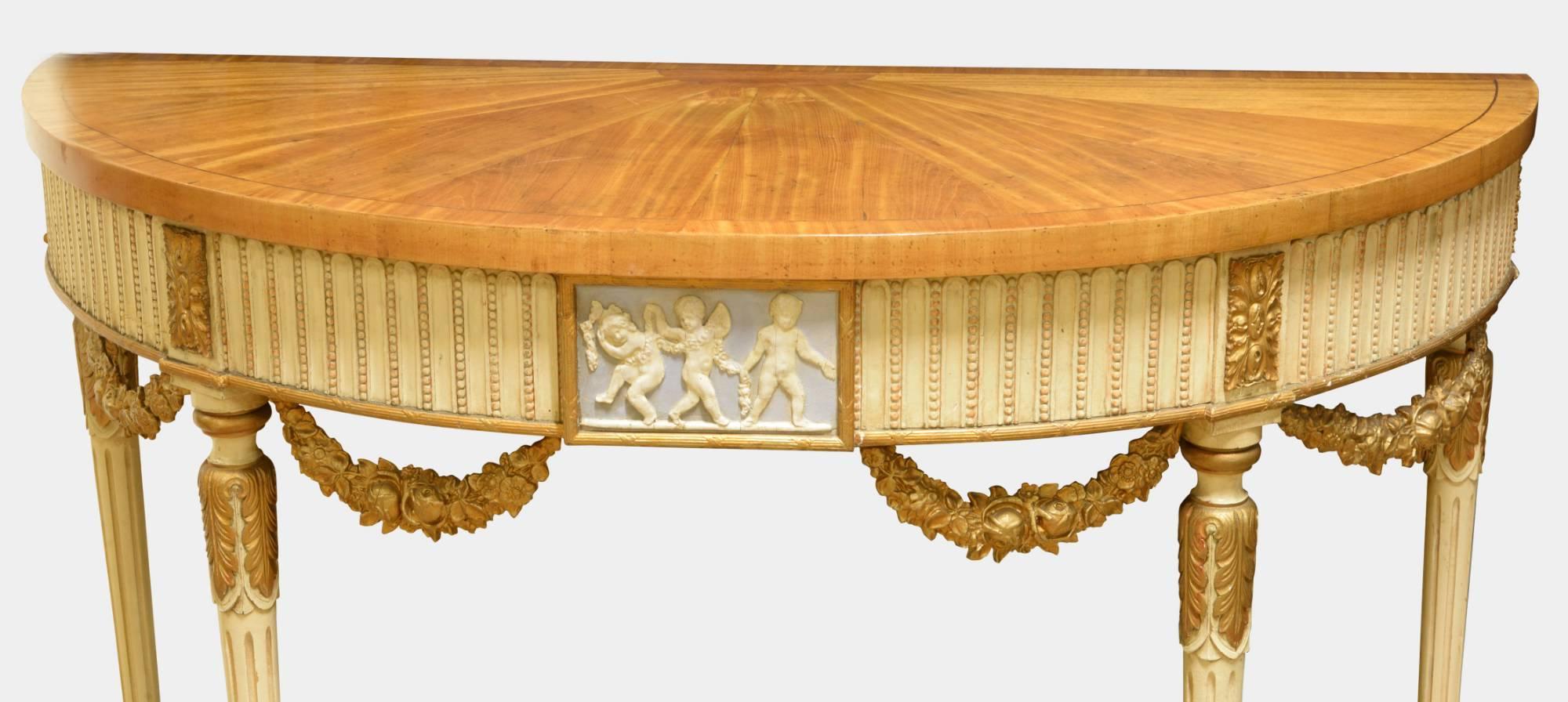 A decorative pair of French console tables with segmented satinwood tops and original parcel-gilt painted bases. Wedgewood style inserts,

circa 1920.