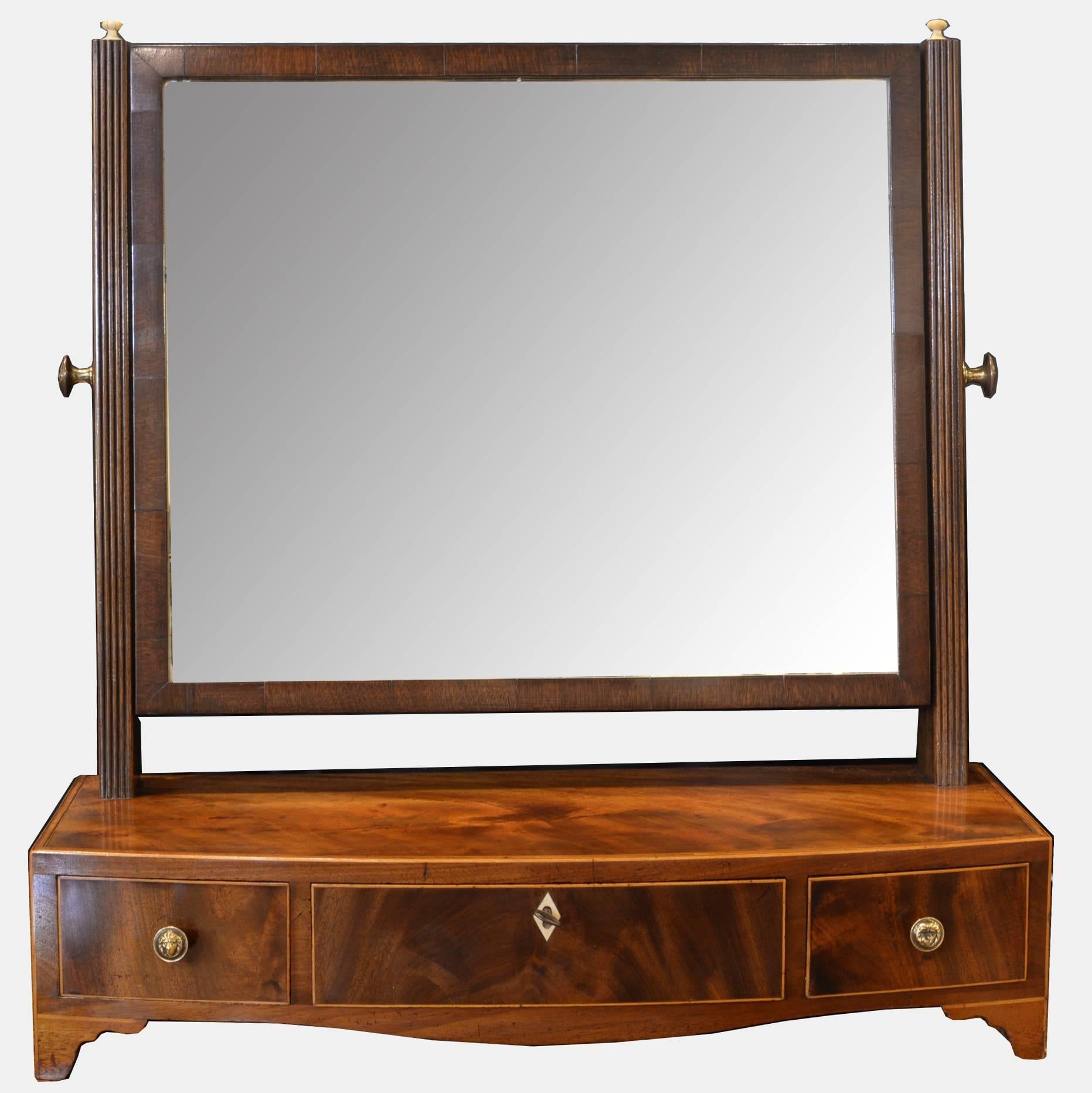 An 18th century mahogany bow fronted box mirror with boxwood stringing.

circa 1790. Original mirror.