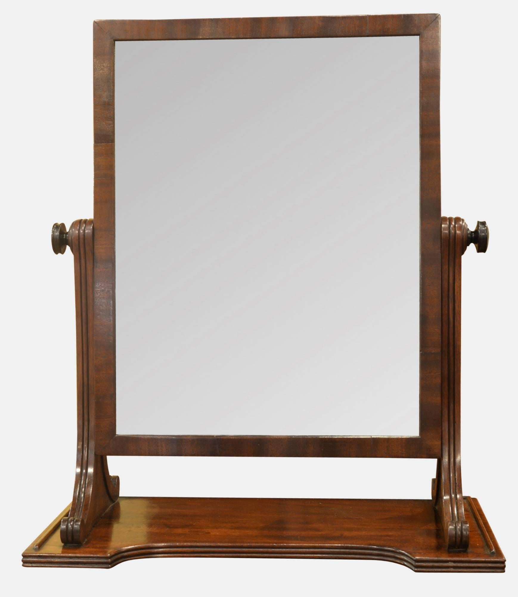 An early 19th century mahogany swing mirror in the manner of Gillows.