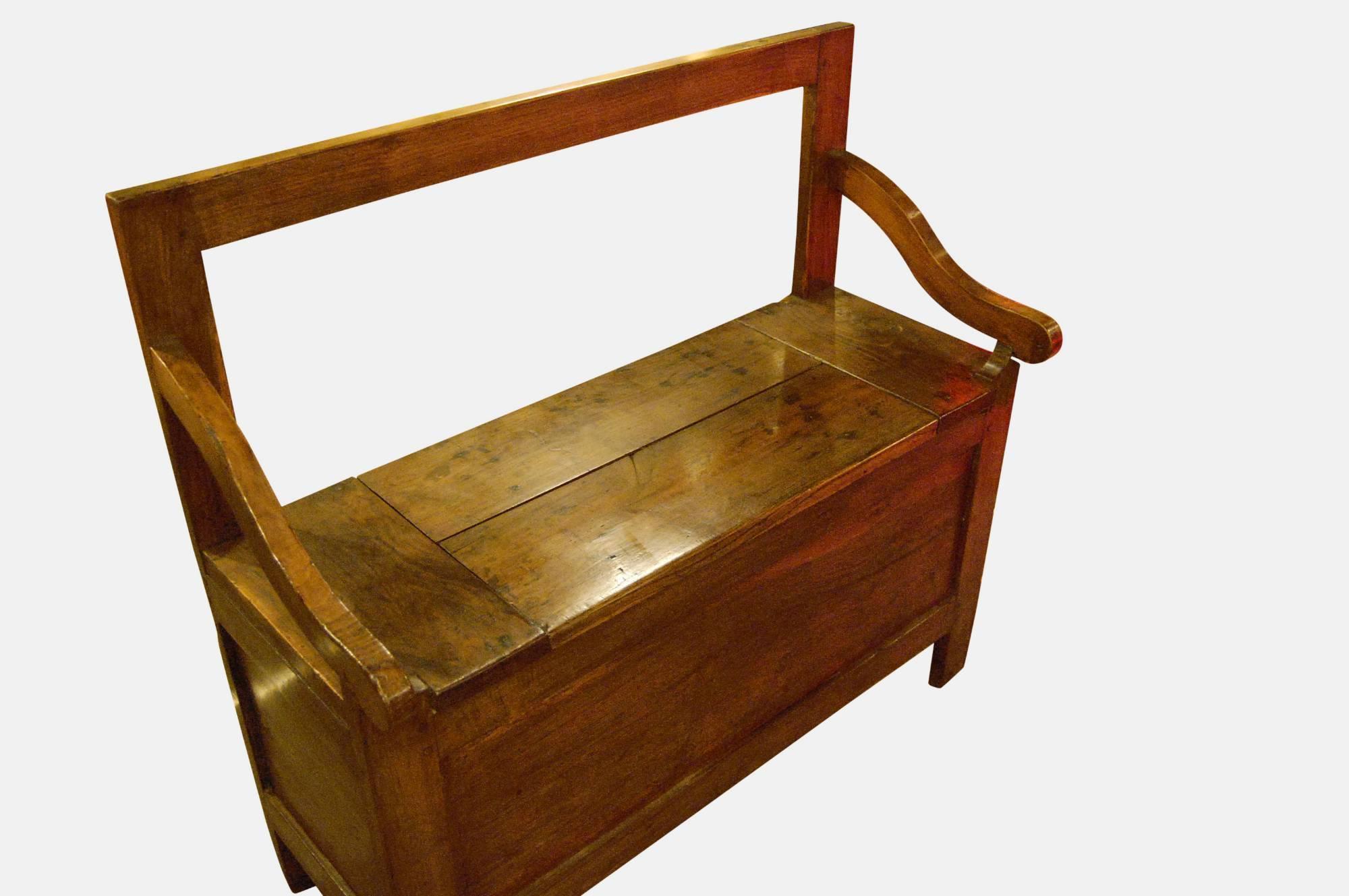 French chestnut bench with lifting seat,
circa 1890.