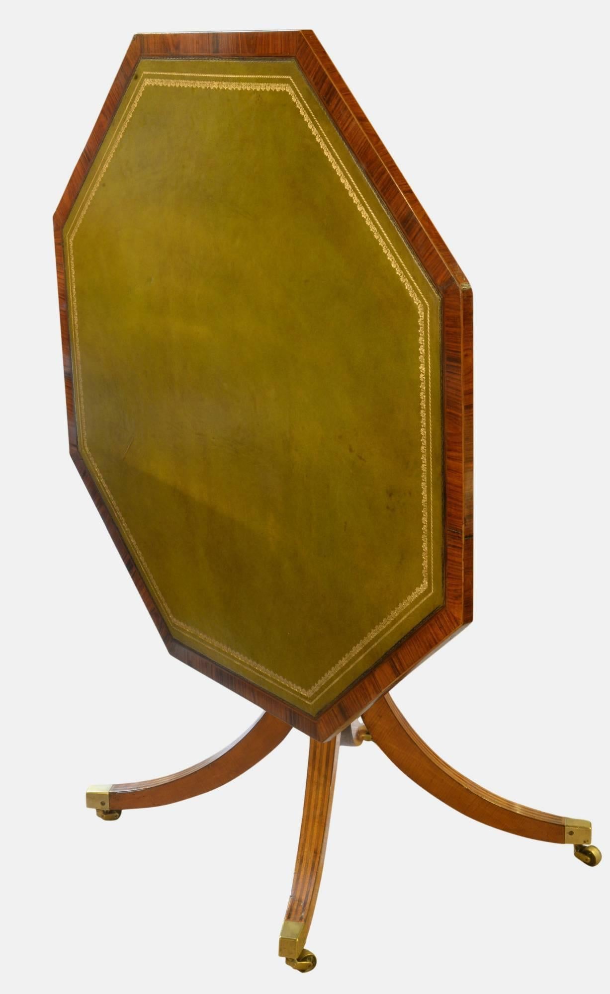 A George III satinwood and rosewood octagonal centre table with replaced leather inset top on splayed legs with brass castors, 
circa 1790.
Dimensions: 70cm (27.6