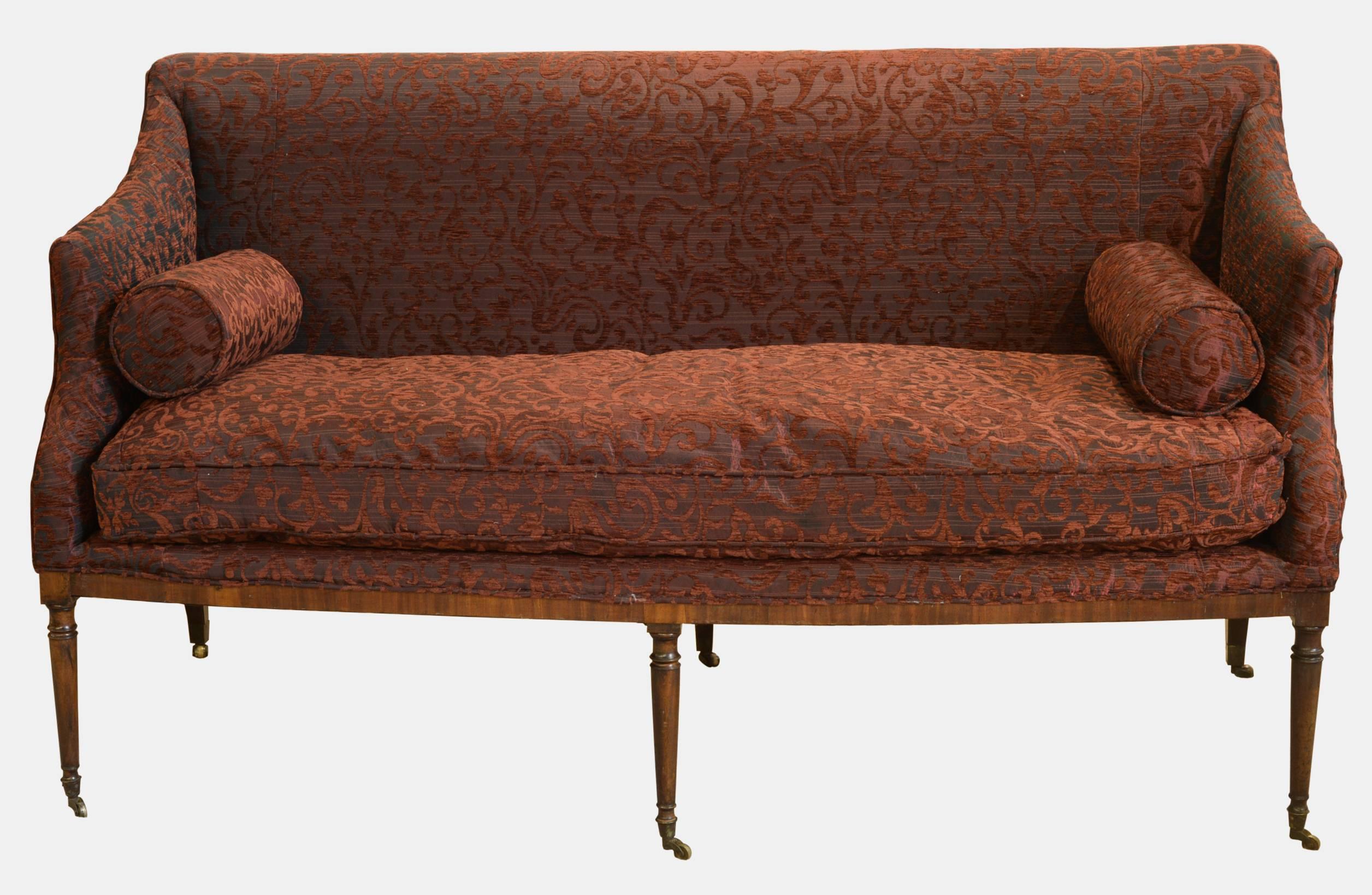 A George III mahogany framed sofa on fine turned legs, with framed castors,

circa 1790.