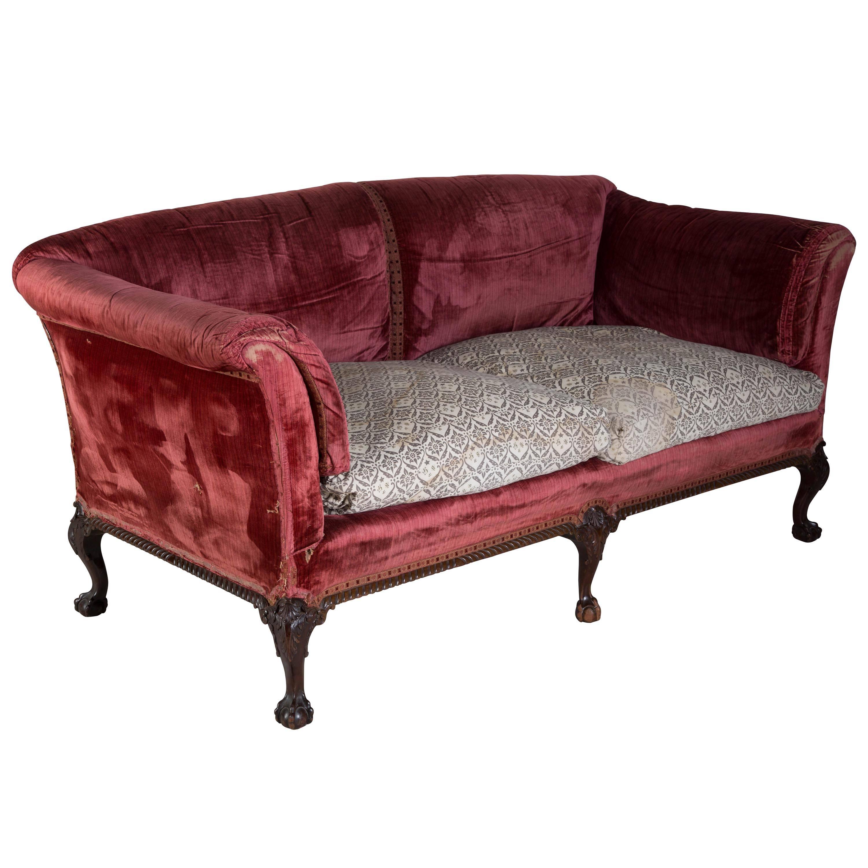A extremely comfortable large two-seat Howard sofa standing on mahogany ball and claw feet, removed from a Scottish country house. Seat depth 54 cm.