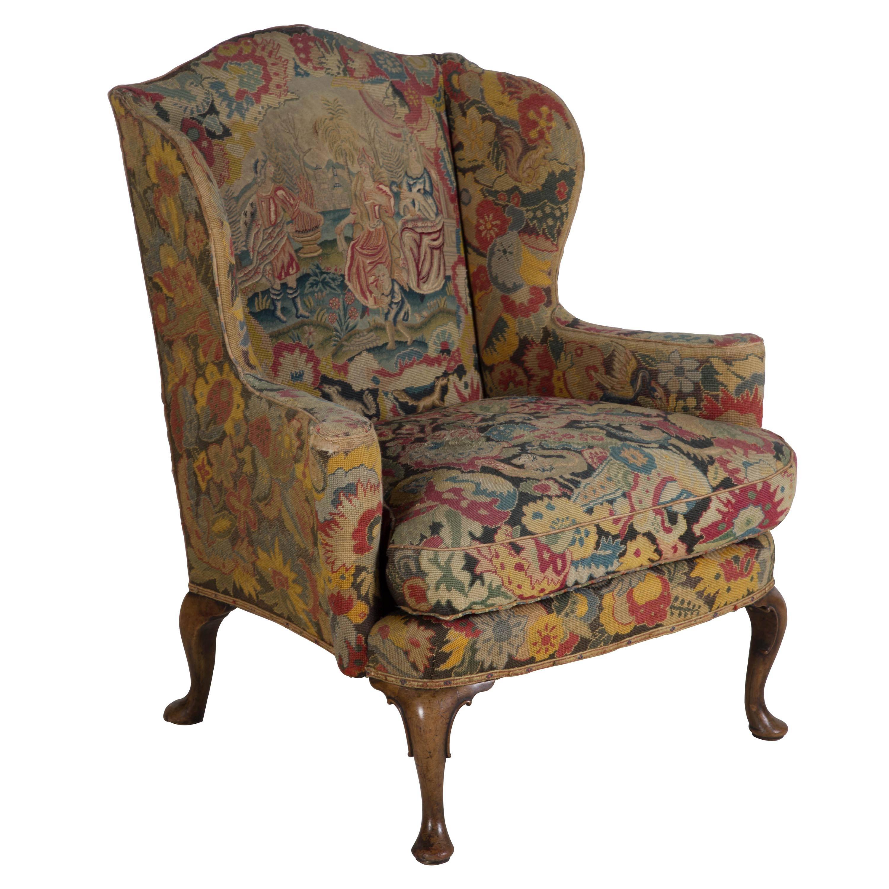 A stunning and wonderful scale George II period wing armchair on walnut cabriole legs, in charming, but worn, original needlepoint, circa 1740. Seat depth 40cm.