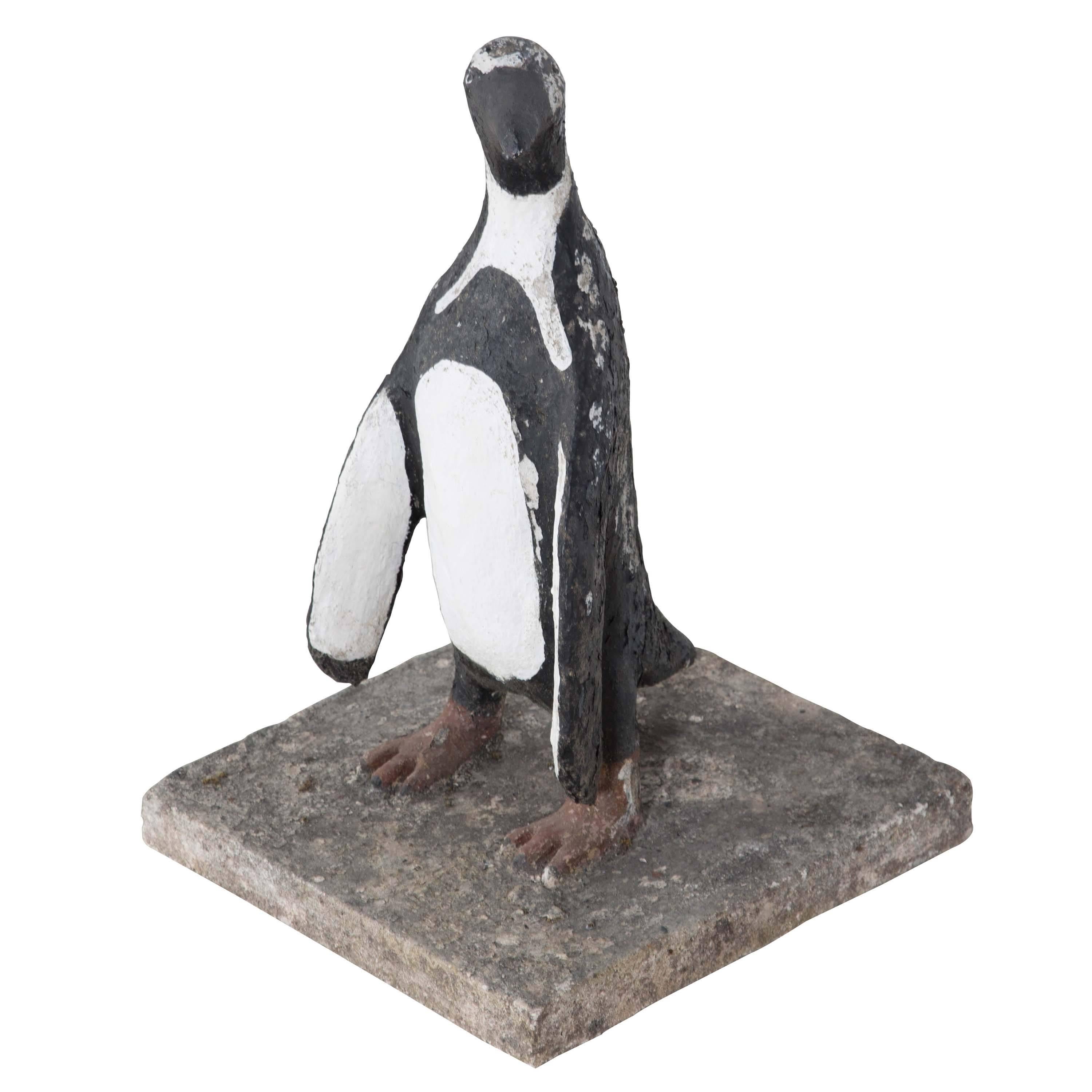 Fun decorative painted penguin on concrete base.
