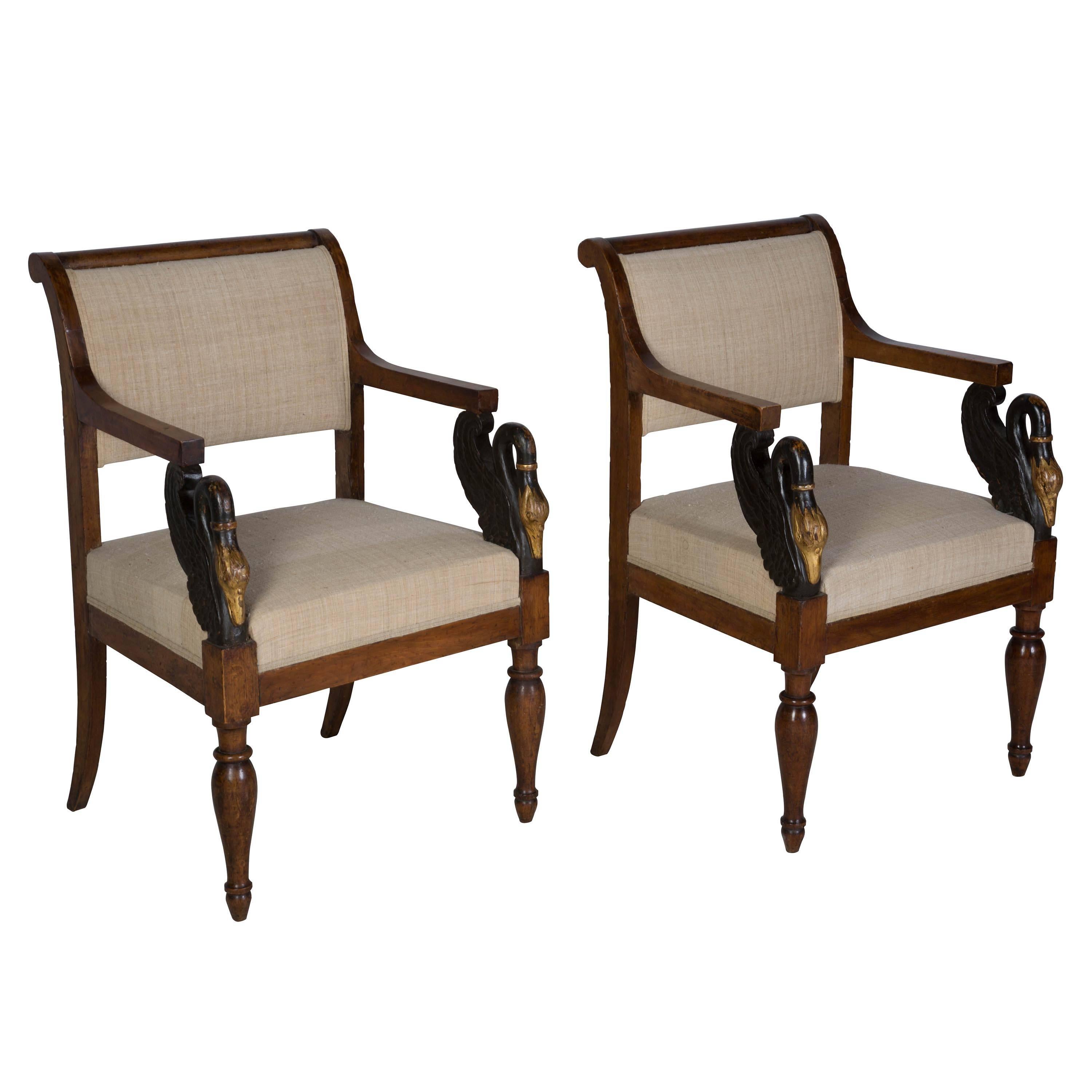 Beautiful pair of early 19th century Italian chairs in walnut with gilded and ebonised carved swan decoration.