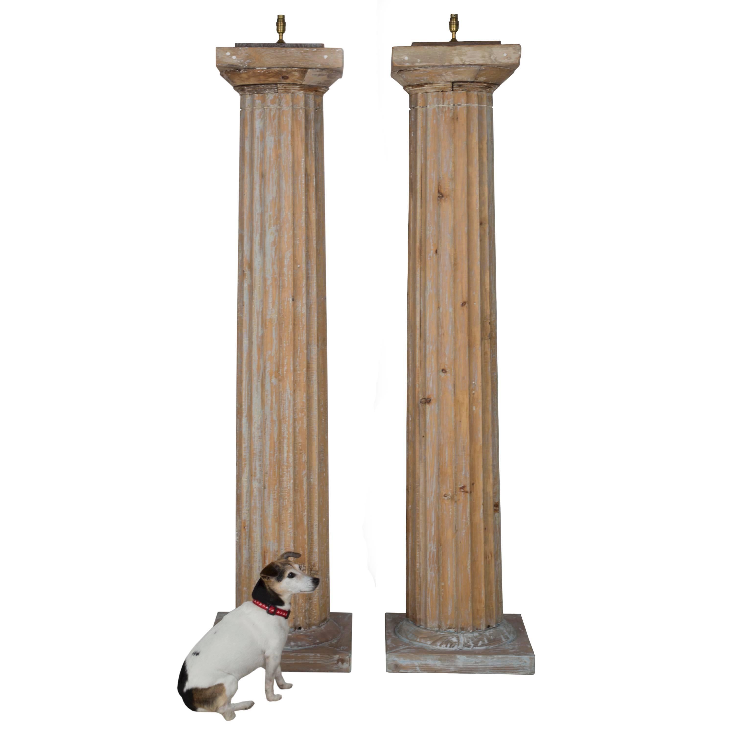 A wonderful over scale pair of mid-late 19th century fluted pine columns in traces of early paint converted to lamps. 