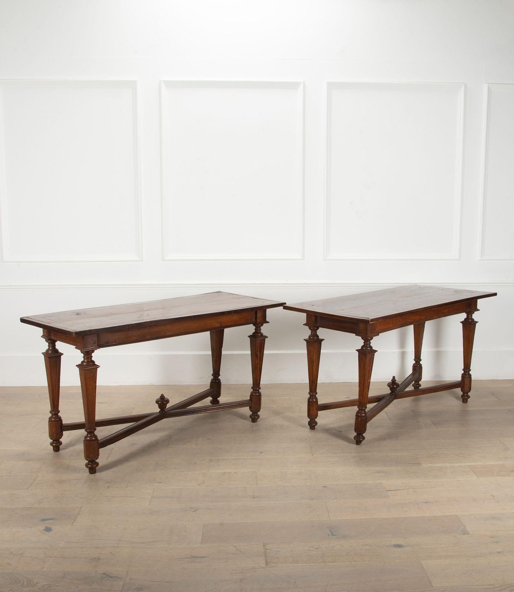 Handsome pair of 18th Century walnut console tables from Tuscany, circa 1760. 
In the Neo-Classical taste with elegant carved details to the legs terminating in a central finial.