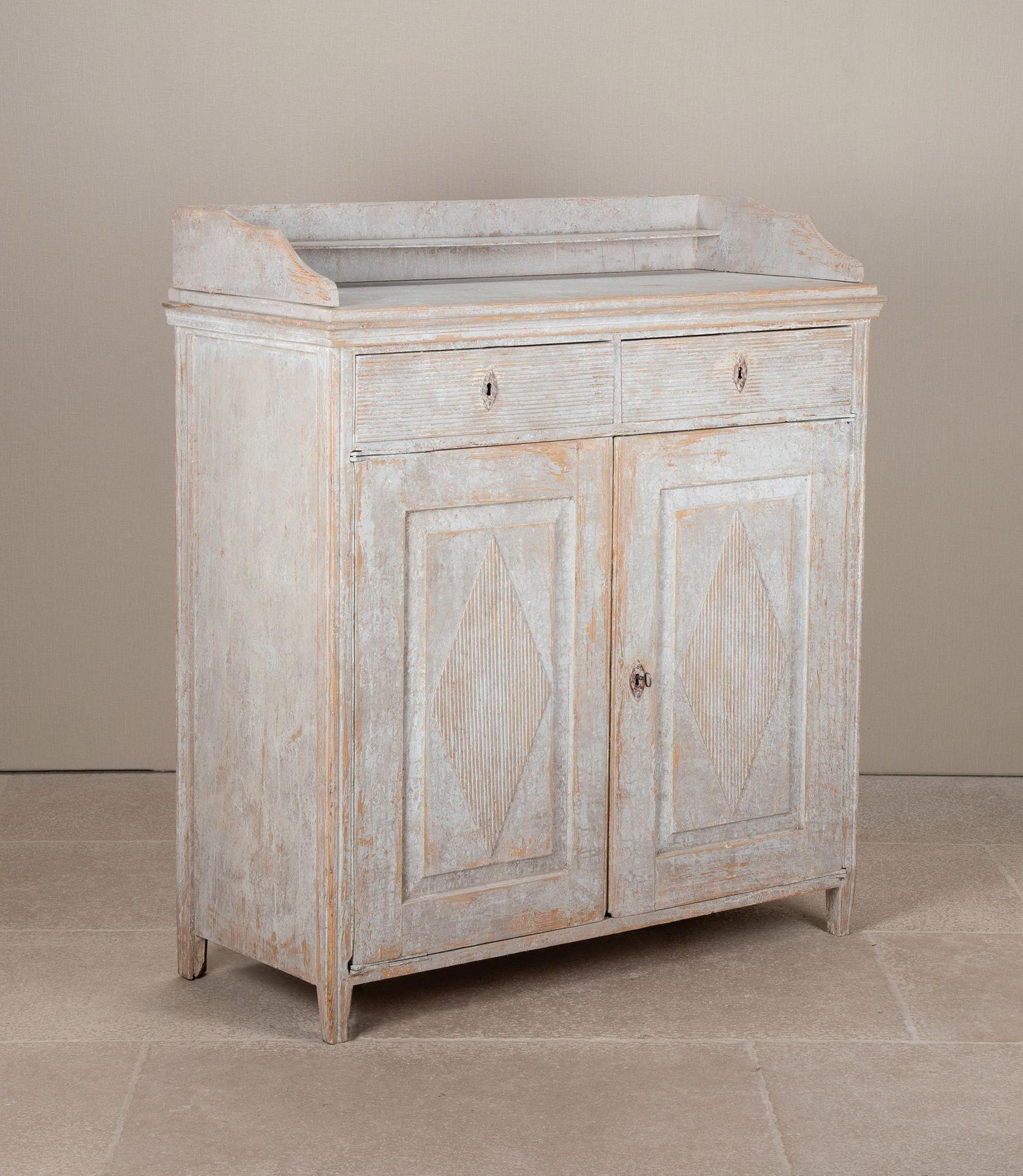 An elegant and well-carved Gustavian buffet from Sweden, Circa 1790. 
This piece reflects the refined Neo-Classical lines of the period, with panelled doors featuring distinctive reeded diamond motifs. The surface has been sympathetically repainted