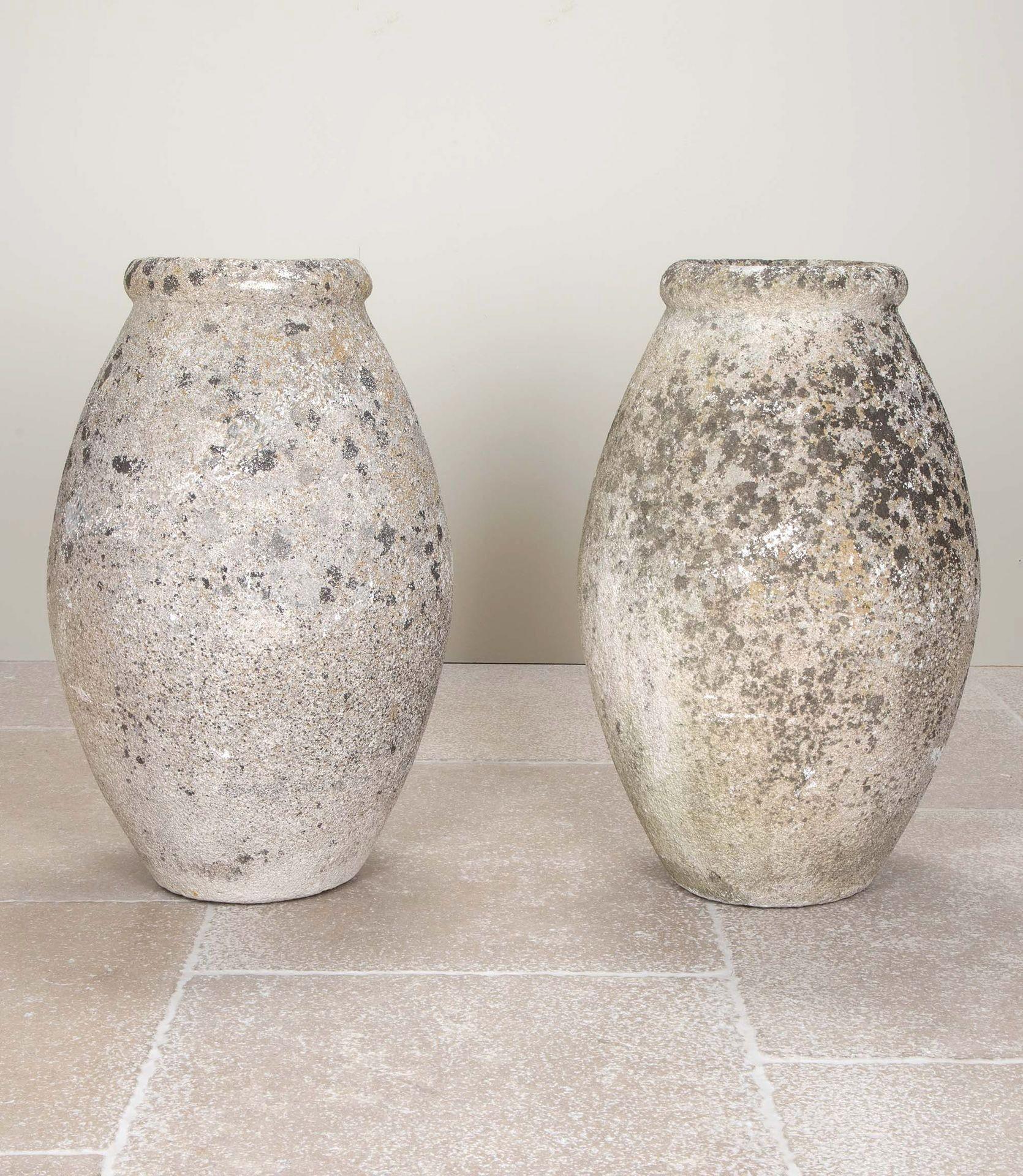 A pair of elegant tall, early 20th Century French, reconstituted stone urns.
Circa 1900.