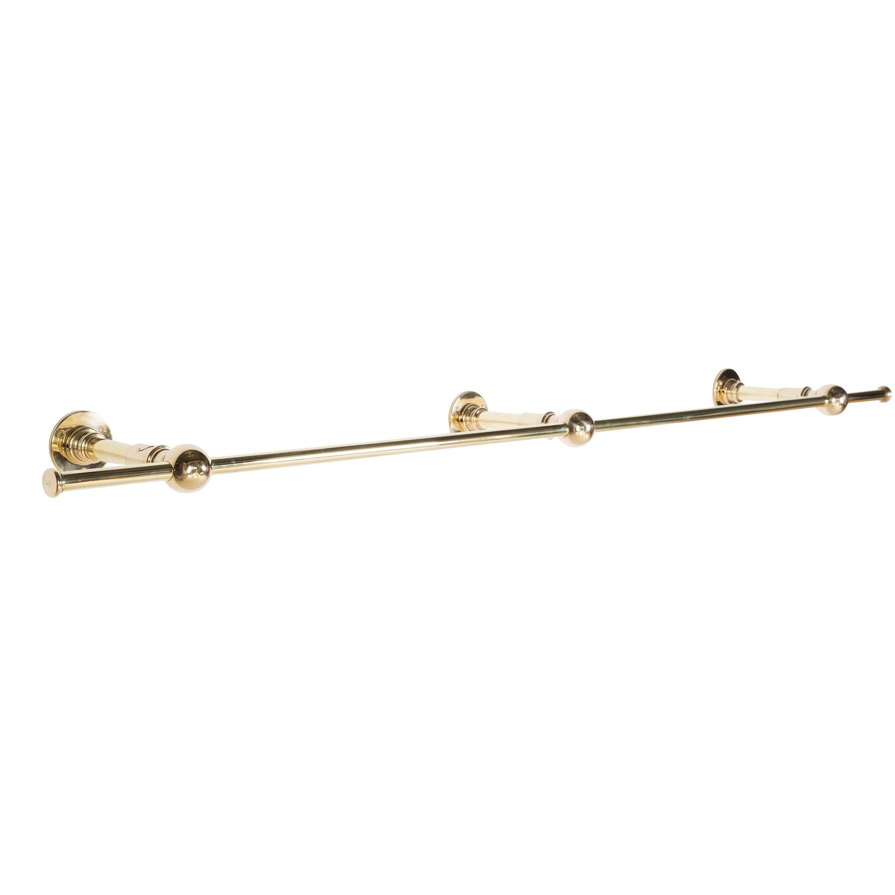 A vintage style wall-mounted clothes rail, with a triple wall fixing point. This clothes rail is tailor made to order from the finest quality polished brass in our workshop in England. No trade discount. Please note that bespoke sizes and metal