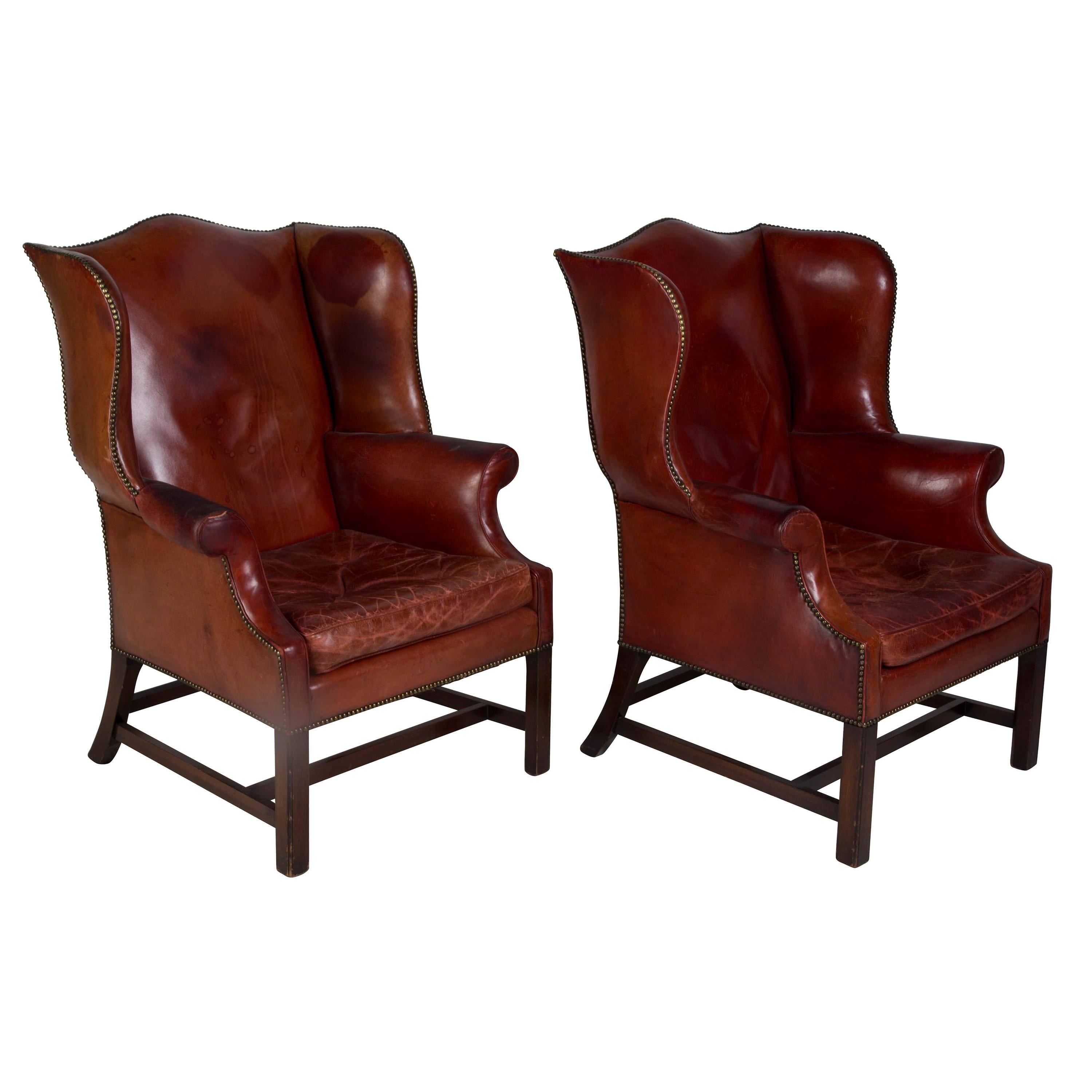 A sumptuous pair of red leather English wingback armchairs, circa 1900. Superb shape, scale and movement. Seat height 46 cm. Seat depth 53 cm.