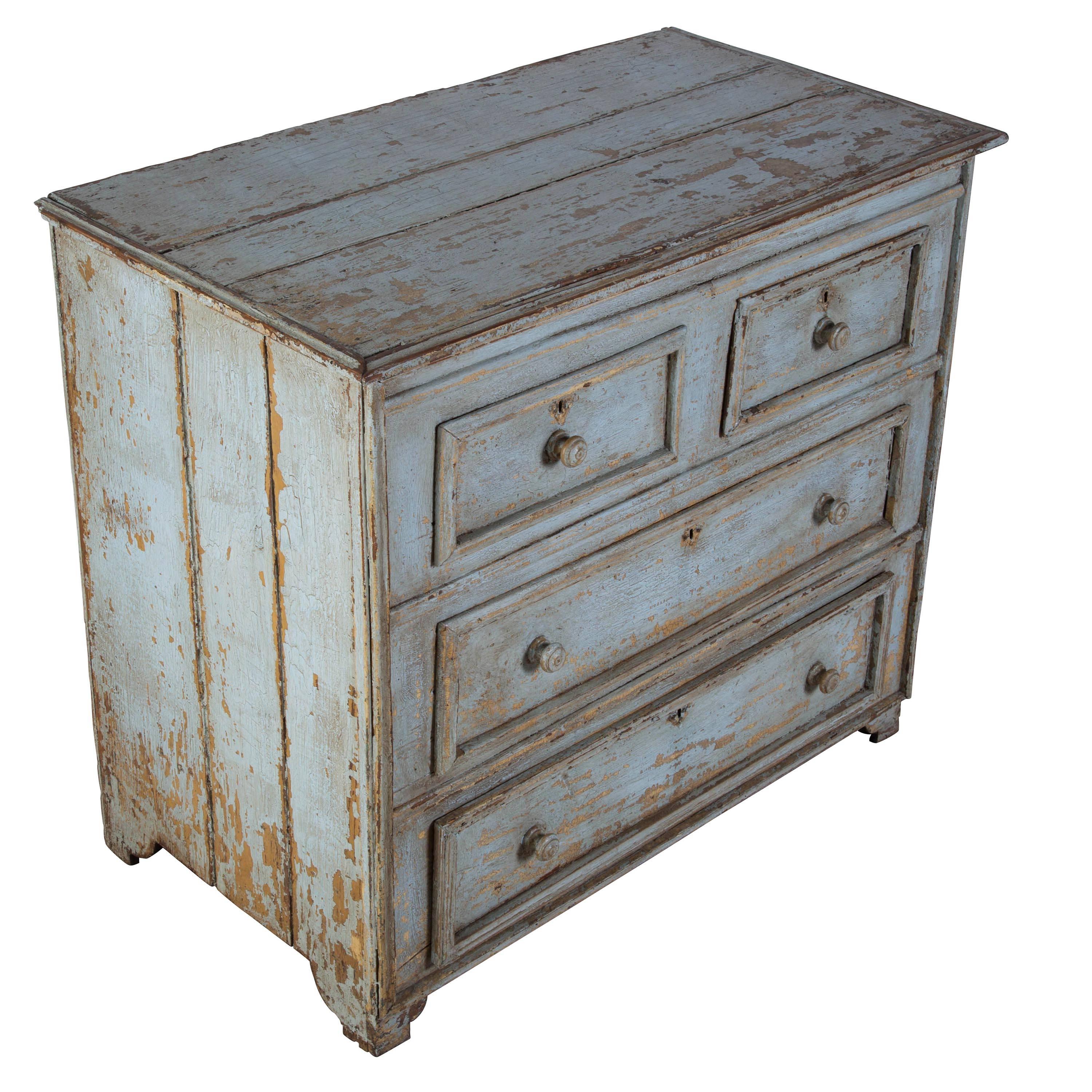 An early 19th century Provincial Italian chest of drawers in remnants of early paint.