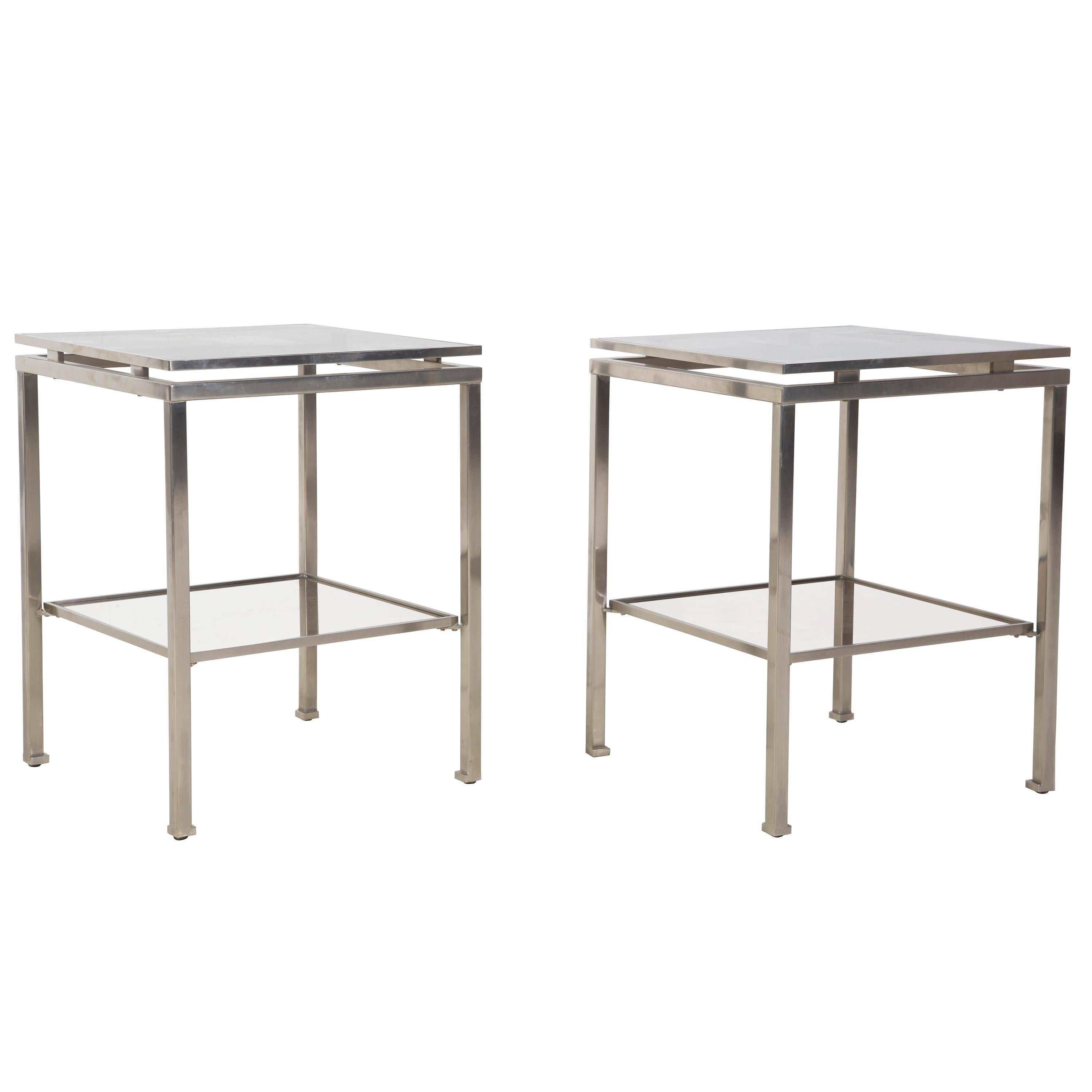 A pair of Guy Lefevre designed brushed steel side tables.